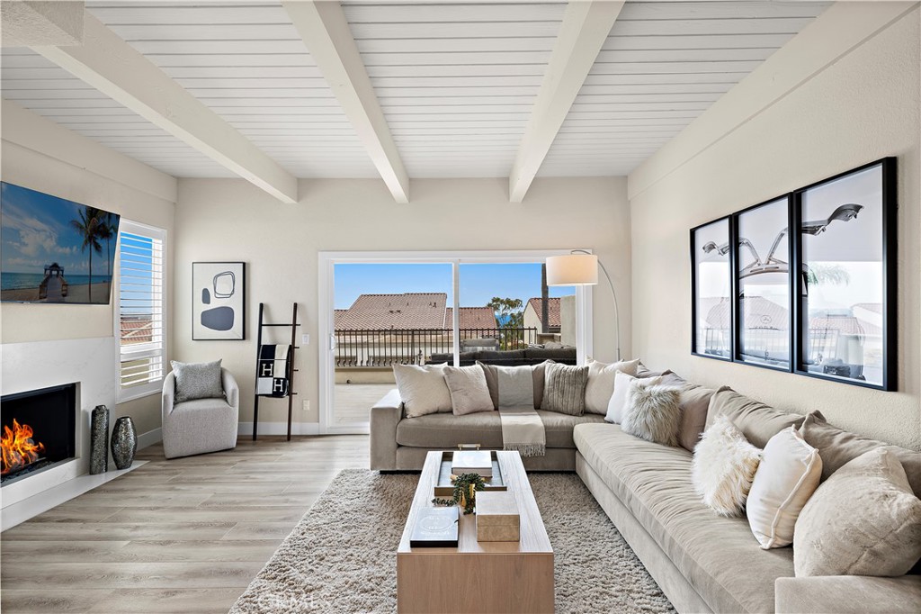 Located in the prestigious enclave of Monarch Beach within the secluded gated community of Monarch Bay Villas, this remarkable ocean-view end-unit villa has recently undergone an extensive and meticulous renovation from top to bottom including new PEX piping, sliding glass doors, new duct & heating system, water heater, recessed lighting, new air conditioner, top of the line whole house water filtration system, Insta Hot water system, new kitchen, new baths, wide plank flooring, custom closets throughout, custom window coverings throughout, new decks, fencing, hard and soft scape, landscaping, irrigation, new fencing and much more. The spacious living room serves as a captivating focal point with its lofty wood-beamed ceilings, inviting fireplace, and, notably, the allure of the large private balcony offering refreshing ocean and golf course views. The expansive gourmet kitchen showcases elegant custom cabinetry, quartz countertops, a large island at its center, and top-of-the-line built-in appliances, including a 42" refrigerator, dishwasher, gas range & oven, disposal and trash compactor. Just off the kitchen, enjoy some downtime in the family room or embrace the indoor-outdoor lifestyle on the well-appointed private patio awaiting you with hard and soft scaping and private hot tub. Upstairs, the primary suite offers a private ocean view balcony. The home boasts white water views of Salt Creek Beach as well as Catalina Island to the Dana Point headlands, the iconic Monarch Beach Golf Links the oceanfront golf course designed by premier golf course architect Robert Trent Jones Jr., majestic landscapes of two world-class luxury resorts—the Ritz Carlton and the Waldorf Astoria. An oversized 2 car garage has built in storage cabinets and a large separate storage closet and an EV charger. The Monarch Bay Villas community provides direct trail access to the Salt Creek Trail, Waldorf Astoria, a variety of restaurants, cafes, salons, fitness facilities, and shopping destinations at the nearby Monarch Bay Plaza. All residences within Monarch Bay Villas received a new clay tile roof and freshly painted exteriors in 2022. Whether you seek a primary residence or an enchanting vacation retreat, this extraordinary opportunity invites you to own your slice of coastal paradise in the hidden gem of Monarch Bay Villas. Community amenities include a private pool, spa, clubhouse, billiards room, fitness room, dry sauna, restrooms, open green spaces and barbecue area.