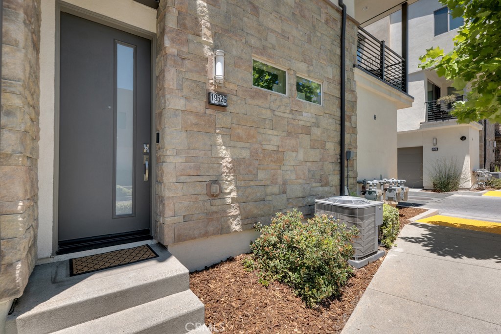 It’s all about the location! This beautiful 3 bedroom, 2.5 bath townhouse (end unit, no one is above or below you) at the highly desirable gated community at “The District” has it all. As you enter you are struck by the abundance of natural light and open floor plan with gorgeous hardwood floors throughout the home. The main level integrates the kitchen, dining room, and living area into one continuous social area, emphasizing its spaciousness, functionality and aesthetic appeal. The main area leads to a patio giving the property an indoor/outdoor flow. The large gourmet kitchen is perfect for the chef in the family and boasts high-end stainless-steel appliances, custom cabinetry, granite countertops, subway tile backsplash with an oversized island with endless storage – perfect for entertaining and daily meals. The large windows invite natural light, making the space feel bright and welcoming. All bedrooms are on the top level. You have 2 generous-sized bedrooms with hardwood floors and double mirror closets that share a hallway bathroom with shower/tub and high-end cabinetry. The large master features hardwood floors, attached bathroom with, high-end cabinetry, walk-in shower, and walk-in closet. Gorgeous high ceilings can be found in the primary bedroom that features a large walk-in closet, custom cabinetry and vanity, with ensuite bathroom that has a walk-in shower. The two spacious secondary bedrooms have hardwood floors and double mirror closets. The laundry is conveniently located upstairs. Other notable amenities include tankless water heater, oversized 2-car garage, and ample storage. Well maintained GATED community, low HOA with exclusive amenities including a resort style pool, spa, BBQ area, bar area, dog park, open lawn and much more! Located minutes from Porto's Bakery, Northridge Mall, and walking distance to California State University, Northridge and an array of dining and shopping destinations. Enjoy the virtual tour. Come tour this beauty as it won’t last!
