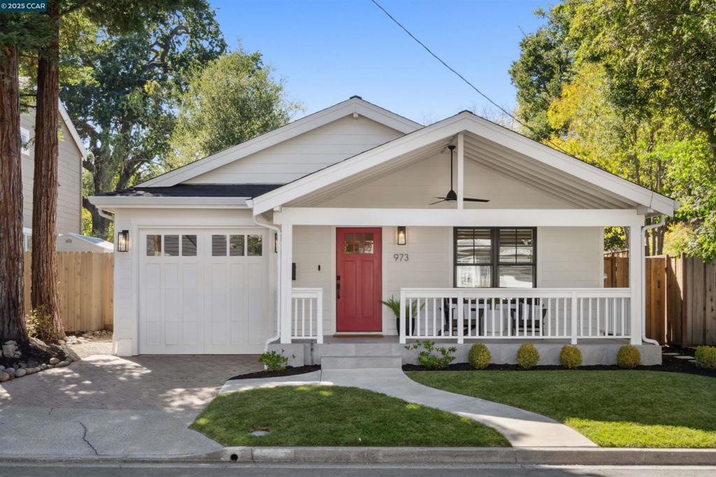 Discover 973 4th Street, beautifully updated in 2020, this 3-bedroom, 2-bathroom home is nestled on one of downtown Lafayette's most coveted cul-de-sacs. This charming single-level, 1,464± sq. ft. residence sits on a peaceful lot and welcomes you with inviting curb appeal and a deep front porch, perfect for morning coffee with neighbors. Inside, stunning oak hardwood floors flow seamlessly throughout, while custom casework and architectural details create a refined atmosphere. The open-concept kitchen and family great room showcase vaulted ceilings with multiple skylights that flood the entire space in natural light, creating a bright and airy environment. Step through sliding doors onto the tranquil, expansive deck where you can enjoy outdoor dining, afternoon lounging, entertaining guests, and embracing Lafayette's celebrated indoor/outdoor lifestyle. The spacious primary suite features large, bright windows with deck access, a thoughtfully designed en suite bathroom, and generous closet space, while two secondary bedrooms offer flexible living options. The finished garage provides weather-tight parking plus versatile options for additional storage, project space, or even a home gym. Perfectly positioned minutes from Highway 24/680 and Lafayette BART.