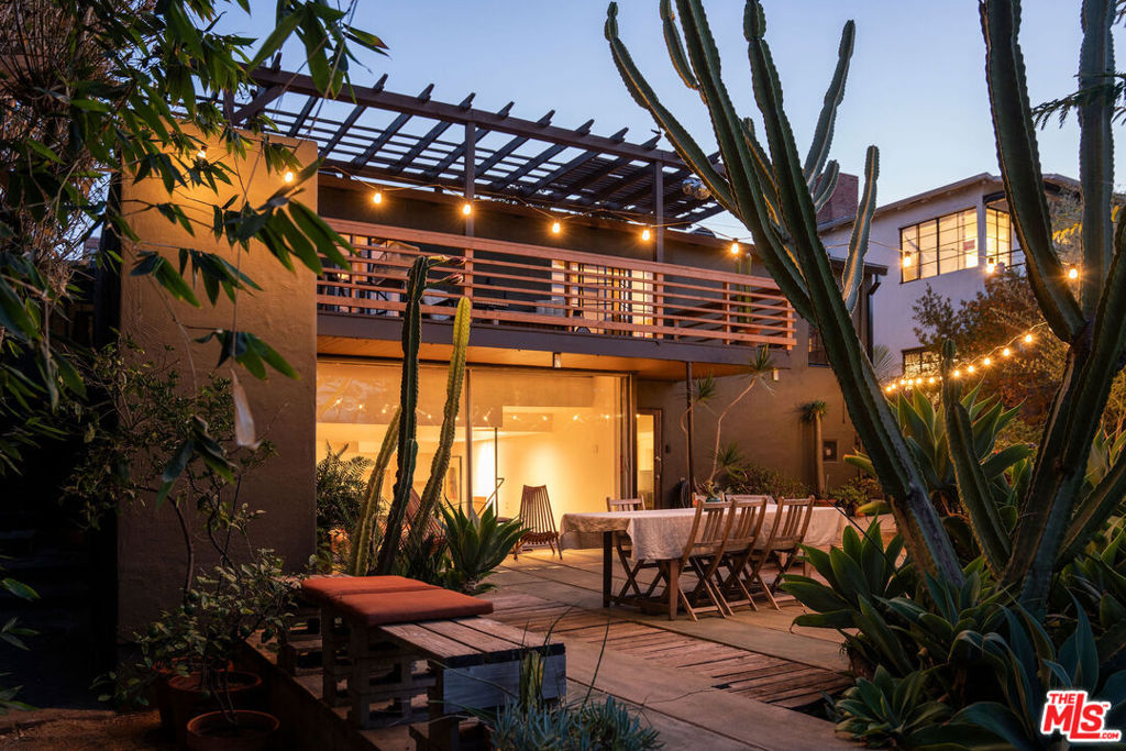 :: The Haft Residence A Masterpiece of Timeless Design :: Originally crafted in 1935 and thoughtfully expanded in 1954 by the legendary architect John Lautner. 2521 W 5th St. is a one of a kind, intentional fusion of romantic 30s hacienda and poignant 50s mid century architecture that has been passionately upgraded and restored over a 25 year period by the current owner. Two iconic phases of the development of Los Angeles, blended into one unparalleled property. Set behind a private gate and embraced by a verdant, serene courtyard, the home's original 1935 core exudes warmth and character. A rustic living room retains its original wooden floors, stained beamed ceilings, Malibu window tiles, built-ins and character rich plaster walls. Natural light beams through original metal windows that showcase mountain views and thriving, drought tolerant landscaping. Between two large and bright bedrooms is a classic and colorful turquoise and yellow 1935 deco bathroom, that remains beautifully intact. The living space progresses into an eating area that has additional original built-ins and exterior deck access, inviting indoor-outdoor living. Beyond a decorative scalloped archway is a stylish and large kitchen. The past shines along with the present, showcasing classic artisan deco tile work. Wide plank rustic floors marry the memorable with the modern with accompanying upgraded soapstone counter tops and Blue Star 6 burner gas stove and range. A long laundry space with a timeless quarter bathroom also leads to a large deck that has broad views with versatile uses such as entertaining, peace and tranquility, evening dinners and morning coffee. Down a staircase and at the beginning of the rear exterior is an unexpected wall of glass, the introduction into a lower bonus space, originally designed by John Lautner to be a den. Lautner's sleek style during his early work is on display. Sharp, dramatic angles overlook dark ruby Saltillo tiles. Very smartly designed by Lautner, the space also conveniently has separate storage space, additional bathroom and kitchenette and is versatile for multiple uses. The beautifully landscaped, tiered yard has separate spaces to entertain or relax by a cozy fire. Many upgrades including central HVAC, gas line replacement, upgraded electrical panel, drainage improvements , sound proofing between both upper and lower structures and more. Centrally located to Silver Lake, Echo Park, Los Feliz and DTLA. An incredible rarity and display of the architectural past brought into the future.