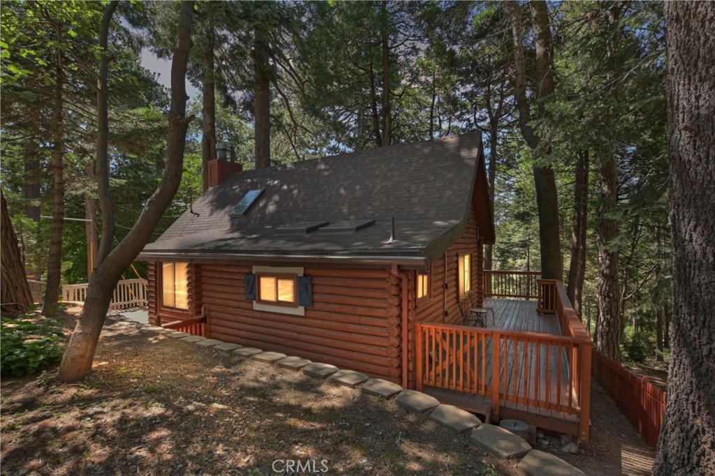 Charming Log Cabin Retreat in the Heart of Arrowhead Villas
Welcome to your mountain escape! This beautifully maintained log cabin offers the perfect blend of vintage charm and modern comfort. Featuring 1 bedroom and 1 full bath, the home boasts vaulted ceilings, warm wood floors, dual-pane windows, and skylights that fill the space with natural light. The cozy living room with a stone fireplace creates an inviting atmosphere year-round, while the updated kitchen and adjacent den provide functionality and flexibility.
Step outside to enjoy the peaceful surroundings from the wraparound deck—perfect for morning coffee or evening gatherings. Pride of ownership is evident throughout, with thoughtful upgrades made by the current owner. The HOA covers water, trash and snow plowing, a great deal!
Nestled in the historic Arrowhead Villas community—once home to Bugsy Siegel’s infamous speakeasy, now known as the Tudor House—you’re just minutes from Lake Arrowhead Village, SkyPark at Santa’s Village, hiking trails, and dining. With easy access to Highway 18, this location is ideal for both full-time living and weekend getaways.
Don’t miss this one-of-a-kind mountain gem