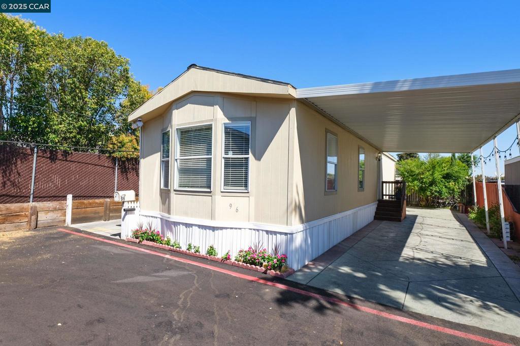 Spacious and full of potential 2-bedroom, 2-bathroom mobile home of comfortable living space, Desirable family friendly park, pool, clubhouse and is meticulously maintained. Situated in a great location close to schools, shopping, dining, and major freeways.The open floor plan, expansive porch, and large windows offer a bright, airy feel perfect for relaxing or entertaining. The covered carport fits up to 2 vehicles, providing plenty of convenience. Fireplaces: NO