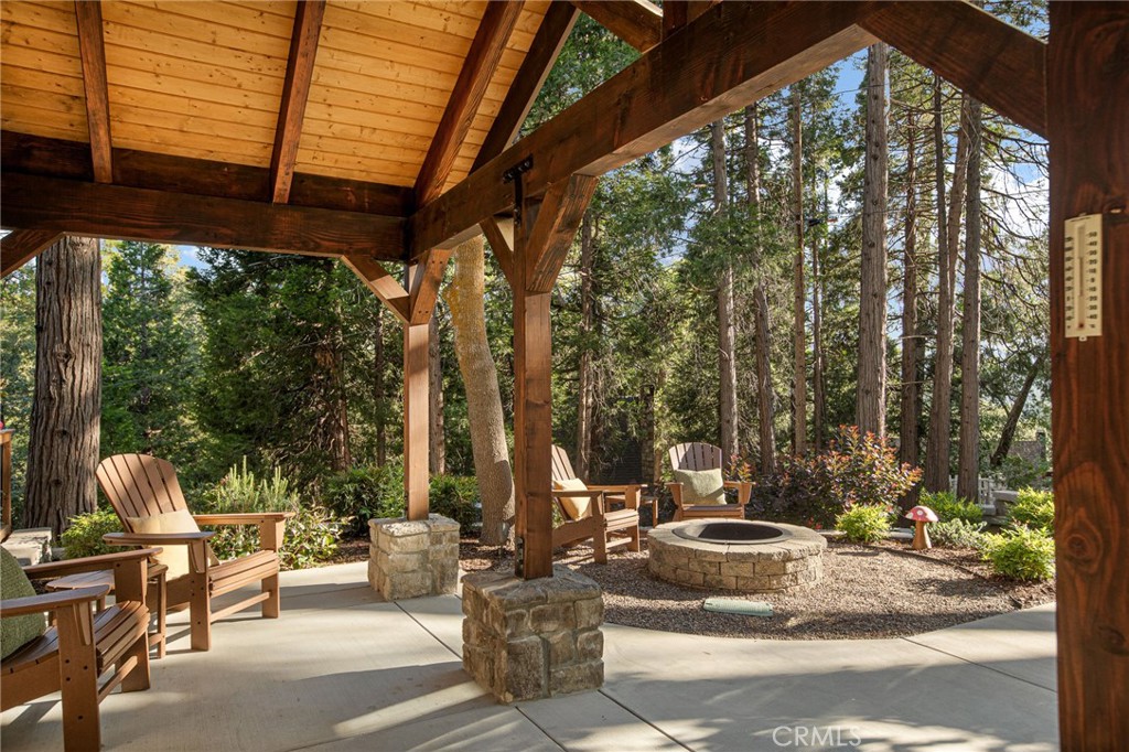 Dreamy Lake Arrowhead Property with Income Potential & Vintage Charm. Welcome to your perfect mountain escape in one of the most sought-after Palisades locations—just a short stroll to beautiful Lake Arrowhead! This corner-lot gem is a rare find, offering two separate living spaces ideal for multi-gen living, renting, or just spreading out in style.The main home is a beautifully updated 3 bed / 2 bath 1926 charmer that blends original Lake Arrowhead character with today’s must-haves. Step past the lush landscaping and cozy front patio (complete with gas fire pit!) and into a warm, welcoming space anchored by a stunning original stone fireplace. The kitchen is a chef’s dream with a 36” Wolf dual-fuel range, quartz countertops, farmhouse sink, shaker-style cabinets, and a 200-bottle wine fridge—yes, please! Both bathrooms have been stylishly remodeled—think modern tile, sleek vanities, and walk-in showers. Upstairs, all three bedrooms offer a peaceful retreat, with the primary suite standing out thanks to its deep green accent wall and built-in cabinetry.Now let’s talk about the courtyard: a private, outdoor hangout space made for entertaining! Covered patio, custom fireplace, built-in grill with side burners...this space is ready for weekend BBQs or cozy fall nights.The separate 1 bed / 1 bath guest house (located above the oversized 2-car garage) is just as impressive—featuring its own full kitchen with a 30” Wolf range, quartz counters, farmhouse sink, plus a luxe bathroom with a soaking tub, custom cabinetry, and even a Robern mirror. Bonus: there’s a spacious mudroom and laundry area with custom built-ins. Extras you’ll love: mostly irrigated landscaping, a whole-home automatic generator, and dedicated boat/RV parking. Whether you're looking to host, rent, or retreat, this property checks every box with style and ease. You won’t find another like it!