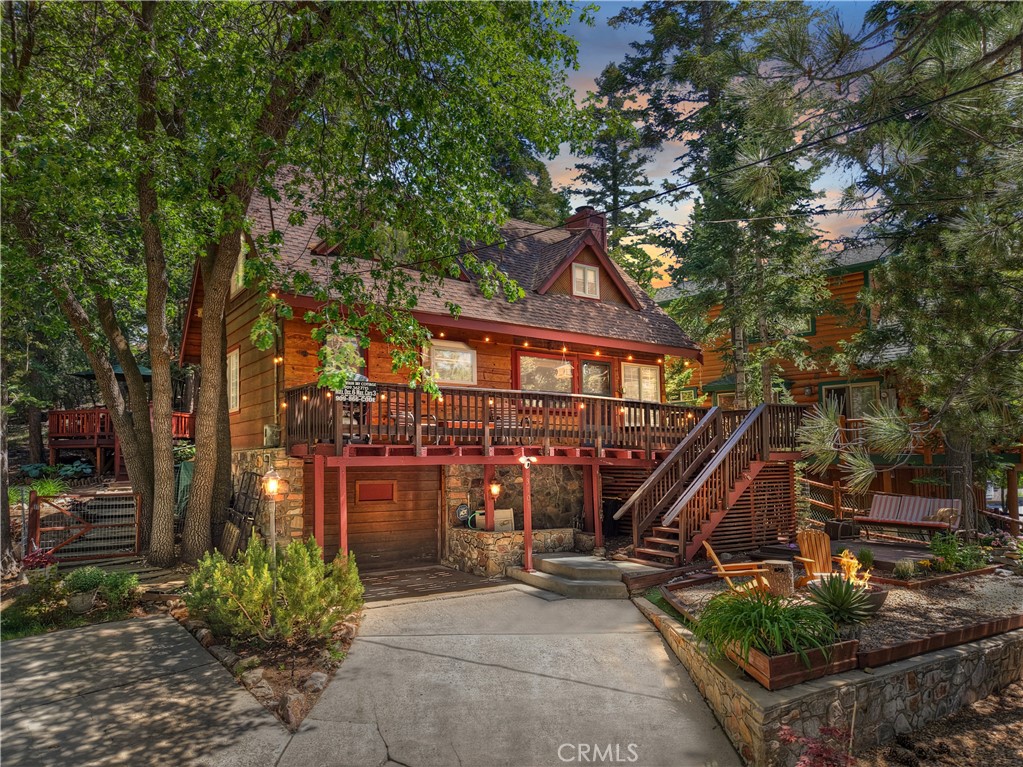 Charming Mountain Getaway in Lower Moonridge! Escape to the mountains and discover this enchanting 3-bedroom, 1.5-bath retreat tucked away in the sought-after Lower Moonridge neighborhood. Brimming with rustic charm and cozy comfort, this cabin offers the perfect setting for year-round memories. The main level features a warm and inviting living space, a convenient full bath, and a spacious bedroom—ideal for guests or single-level living. Upstairs, two additional bedrooms and a half bath provide a quiet haven after a day of adventure. Step outside to your own private mountain sanctuary: a sprawling back deck made for entertaining under the stars, complete with a gazebo and a soothing hot tub—perfect for après-ski evenings or summer nights under the pines. The beautifully landscaped front yard adds a touch of curb appeal and sets the tone for the charm that awaits inside. Just minutes from Bear Mountain Resort, the golf course, Big Bear Zoo, and the vibrant Moonridge Corridor, this location puts you at the heart of Big Bear’s best attractions. Whether you’re carving fresh powder, hiking forest trails, or enjoying coffee in The Village, everything you love about the mountains is right at your fingertips. Turnkey and move-in ready, all of the leg work has been done that makes this home ideal as a short-term rental, second home, or full-time mountain residence—your perfect getaway starts here!