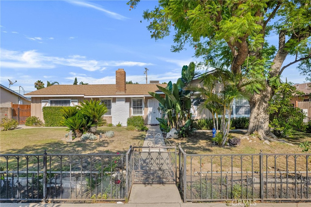Appealing, single story, 3 bed, 2 bath, mid-century rambler style Chatsworth home in friendly, residential neighborhood. Great curb appeal with a large front yard, fully gated with low, decorative wrought iron fencing, and vintage aesthetic of wood siding and decorative shutters on the façade. Security gate opens to a small, covered front porch and on to the entry into a welcoming open plan living space. The living room boasts solid wood parquet floors, large, mullioned windows, and direct access to the back patio. The living room flows into the dining area, boasting tile floor and a commanding, white, brick fireplace, and connects seamlessly to the updated kitchen. The kitchen offers rich wood cabinetry, granite countertops, stone tile backsplash, recessed lighting, and white appliances, and a convenient breakfast bar linking back to the living room to enhance the open concept feel. Down the hall are three good-sized bedrooms, one with tile floors while the others have solid wood parquet , one of which also has a glass slider to the patio. The home also has two, updated, ¾ hall baths one with a tiled shower, one with a tub. An oversized garage, extended with permits, offers tandem parking for up to four vehicles, abundant storage space, laundry area, and potential for conversion to an ADU or guesthouse. Gated driveway access is from the rear of the property, off the alley, and has ample space for RV or Boat parking. The private backyard is ideal for entertaining and everyday living, featuring covered and uncovered patios, perfect for BBQs or dining al-fresco, wide lawn, decorative planters, and stone walkways to enjoy the space. Well situated near shopping, dining, entertainment, and recreational amenities, this property offers versatility, space, and a prime Chatsworth location. Don’t let this one pass you by!