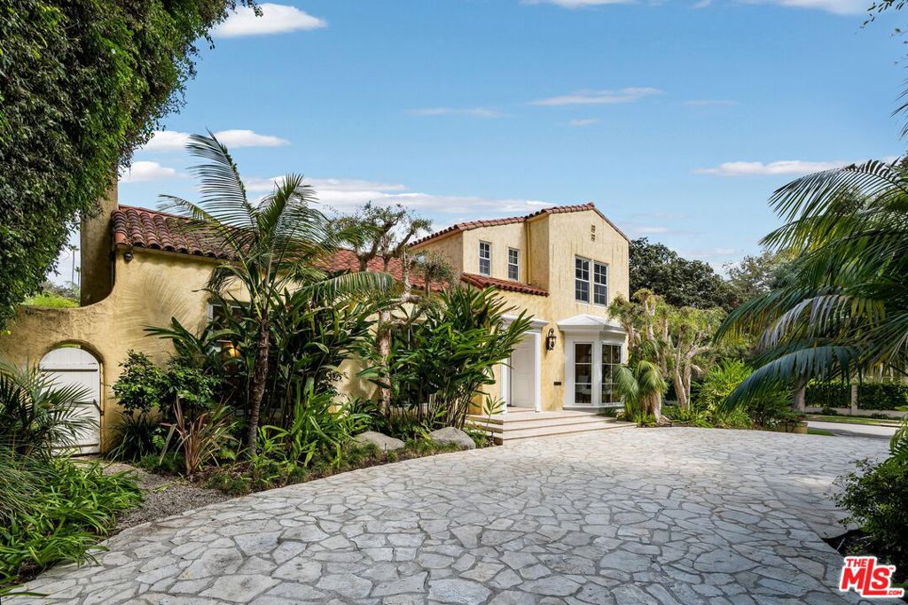 Situated in Beverly Hills' esteemed 700 block of North Rodeo Drive, this celebrity compound radiates luxury on a sprawling 17,000 square foot corner lot. Meticulously landscaped, the property exudes a tropical resort ambience, complete with a pristine tiled pool, spa, adjoining gym and office. The estate boasts a separate guest house and a state-of-the-art recording studio, recognized for hosting rock legends. With parking for 8+ vehicles and multiple access points, this gem is moments away from the heart of the Golden Triangle.