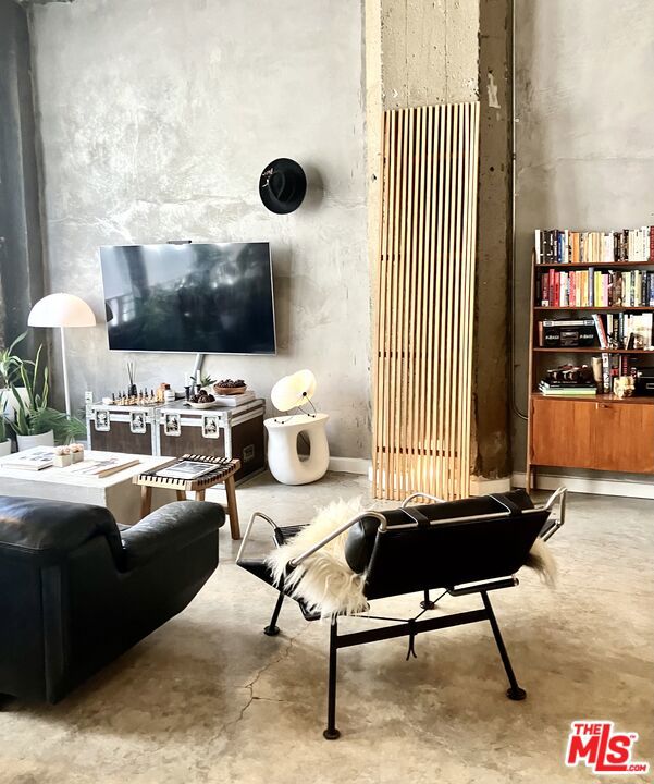 Originally a Los Angeles department store beautifully converted into live/work loft apartments with 14 foot ceilings, exposed concrete support columns and ceilings. Updated with modern stainless steel appliances. Each unit has a full size washer and dryer. Full bath with separate shower stall plus powder room. Rooftop deck with city views includes a Barbecue Grill. Secure underground parking is available. Centrally located near Whole Foods, Los Angeles Athletic Club, Per LA Hotel and Metro Station. This unit is an open floor plan. Northern exposure with city lights view. Inside photos representative of appliances and finishes, may not be for this specific apartment. Shown by appointment only.