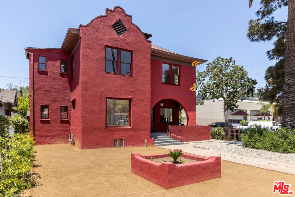 Step into Los Angeles history with the Murdock House, a distinguished 122-year-old Mission Revival residence, designated as Historic-Cultural Monument No. 778. Situated at the base of Mt. Washington in Highland Park, this rare offering blends timeless architectural detail with modern restoration. Originally built in the Four-Square style, the three-story structure features preserved elements such as original hardwood floors, crown molding, leaded glass windows, vintage light fixtures, a grand staircase, built-in window seating, and a decorative fireplace. Currently zoned C4-1XL with Single Family Residential use, the property provides exceptional flexibility for live/work, or creative commercial/retail office use. The main level includes a welcoming living area, a large kitchen space with multiple access points, a formal dining room or conference room, and a half bath downstairs. The second floor offers four private bedrooms or offices and a full bath with a clawfoot tub, while the third story provides an additional private bedroom or office with hillside and mountain views. Recent upgrades include structural retrofitting, new HVAC, updated plumbing and electrical, and fresh interior/exterior paint. The gated lot features drought-tolerant landscaping, mature fruit trees, two off-street gated parking spaces, a single-car garage, and abundant street parking. Previously used as a cafe and most recently permitted for restaurant use, the building's prior commercial use offers additional potential, subject to buyer due diligence. With Mills Act property tax benefits in place and a location at the heart of vibrant Highland Park, this is a rare opportunity to own a piece of LA's architectural legacy with incredible flexibility for future use.