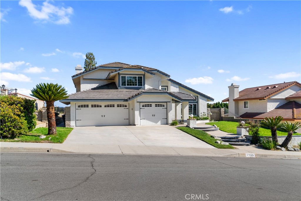 This fully remodeled and thoughtfully upgraded single-family residence is a true hidden gem, tucked away in a quiet cul-de-sac within the highly sought-after Snow Creek community, served by the award-winning Walnut School District. As you step into this model-like luxury home, you’ll be welcomed by an impressive foyer with soaring cathedral ceilings and an abundance of natural light. The bright and airy living room seamlessly connects to the formal dining room, creating an inviting space for both relaxation and entertaining. The chef’s kitchen is a masterpiece, featuring sleek modern finishes, top-of-the-line appliances, ample cabinetry, and a charming bay window that frames tranquil outdoor views. A cozy breakfast nook provides the perfect spot to enjoy casual meals with family and friends. The main floor offers a rare master suite complete with a built-in entertainment center. There is a beautifully remodeled powder room for guests on the main floor. Upstairs, you’ll find two spacious bedrooms sharing a stylish Jack & Jill bathroom, as well as a second master suite that showcases breathtaking views. Nearly every room in the home, from the living and dining areas to the bedrooms, captures stunning vistas. Additional highlights include double-pane windows throughout, fresh interior and exterior paint, brand-new appliances, and a newly installed AC system—no detail has been overlooked. The third garage space has been converted into a home office, and it can also serve as the fifth bedroom. This exceptional home offers both luxury and convenience. It's located just minutes from award-winning Walnut High School, Mt. San Antonio College, shopping, dining, and major freeways. Come and make this exquisite residence your home sweet home!