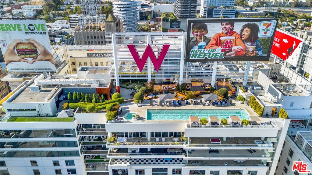 Step into Hollywood glamour with this one-of-a-kind residence at the iconic W Residences once home to an Emmy-winning actress and advocate. Available fully furnished or unfurnished, this designer-curated condo blends modern sophistication with unmatched convenience in the heart of Los Angeles. Inside, floor-to-ceiling triple-paned windows frame vibrant city views while keeping your space serene. The open-concept layout flows seamlessly from the chef's kitchen featuring sleek custom cabinetry, gold-accented fixtures, and premium appliances to the chic dining and living areas perfect for entertaining.Retreat to the spacious primary suite with a spa-inspired bath, complete with dual vanities, a soaking tub, and a walk-in closet fit for a Hollywood wardrobe. For the flex second room, Closet Factory designed and built out a fully customized Glam Room, where the celebrity owner prepared for countless red carpet and award show appearances. This thoughtfully built space boasts abundant storage and a professional vanity setup--perfect for anyone passionate about beauty, influencing, or simply living their most glamorous life. Living at the W means resort-style perks: a rooftop pool with private cabanas, state-of-the-art fitness center, and 24-hour concierge service. Outside your door, Hollywood's best dining, nightlife, and entertainment await. A rare opportunity to own a piece of celebrity real estate history--paired with world-class amenities and a location that's second to none.
