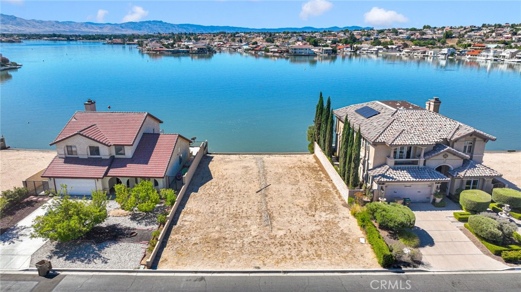 Rare lakefront opportunity in the prestigious Spring Valley Lake community! This premium lot offers the chance to build your dream home and enjoy luxury lakefront living at its finest. Residents have access (with membership) to exclusive amenities including a private country club, championship golf course, sandy beach, parks, and a modern fitness center. Conveniently located near shopping, dining, schools, and freeway access—this is an opportunity not to be missed.