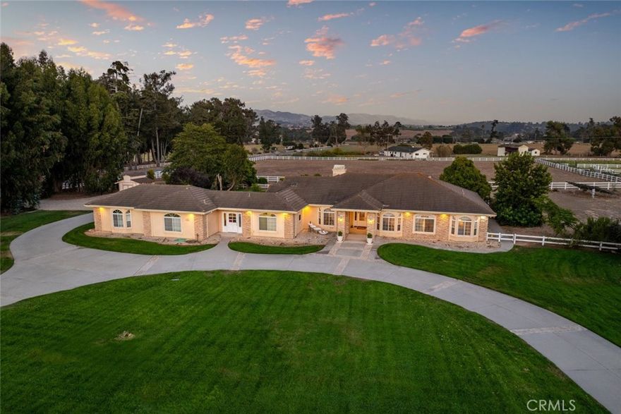 Sophisticated Living on Expansive Grounds.

Set on five picturesque acres in the heart of Arroyo Grande, this custom Greg Nester estate blends timeless craftsmanship with modern luxury, creating a rare sanctuary on California’s Central Coast. With approximately 3,152 square feet of thoughtfully designed living space, the residence offers four bedrooms and three baths in a private setting where horses are welcome. Inside, the home is designed for both relaxed living and sophisticated entertaining. Two expansive living areas are enhanced by built-in cabinetry, a wet bar, and a four-unit entertainment center. The gourmet island kitchen features Bosch appliances, a Jenn-Air cooktop, a walk-in pantry, and ample cabinetry, while the adjoining dining room is perfectly suited for hosting. The master suite offers a spa-inspired retreat with a walk-in shower, complemented by ceiling fans throughout the great room and bedrooms for year-round comfort. A dedicated laundry/mud room with a shower adds both convenience and versatility. Technology and efficiency are integrated, featuring owned solar, Cat 5 wiring, surround sound, a whole-house fan, an intercom, and a full suite of security features, including cameras, motion lights, and a burglar alarm system. Golden State Water Company services the home, while a private well and 5,000-gallon storage tank support the landscaped grounds, complete with sprinklers and drip irrigation. Outdoor living is equally compelling, with a vinyl-fenced perimeter, gated dog run, storage shed, and fire ring for gatherings under the stars. A 4-car garage, plus RV hookups with a dump station, ensures ample parking and storage for both daily living and recreational pursuits. A rare offering of space, privacy, and refinement, 175 Michael Lane captures the essence of Central Coast living—where lifestyle, luxury, and land come together in perfect harmony.