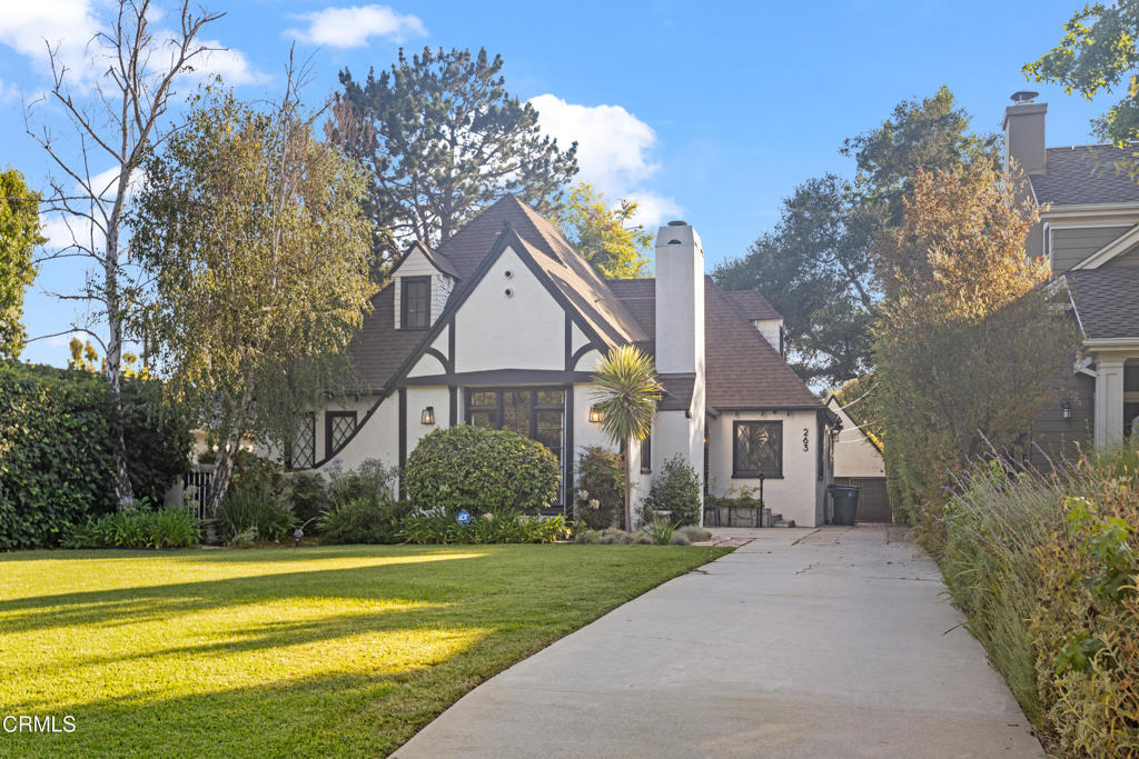 Nestled in the highly sought-after San Rafael neighborhood of Pasadena, 263 San Miguel Road is a timeless 1926 English Tudor residence that blends classic architecture with modern updates. Set on a beautifully landscaped 9,000-square-foot lot, this 3 bedroom, 2.5 bath home offers approximately 2,700 square feet of elegant living space filled with character and natural light. Inside, the formal living room makes a striking first impression with its vaulted wood-beamed ceilings, rich hardwood floors, and a stately fireplace beneath a statement chandelier. Just beyond, a gracious formal dining room with crown molding and tray ceilings opens to a remodeled chef's kitchen featuring granite countertops, stainless steel appliances, a five-burner gas cooktop, and a peninsula with bar seating perfect for everyday meals or entertaining. A cozy den or sitting room sits just off the main living area, ideal for a music room, office, or reading nook, with French doors that lead out to the fully enclosed backyard. Two generously sized bedrooms are located on the main level, alongside two well-appointed hall bathrooms. Upstairs, the primary suite feels like a private retreat with vaulted ceilings, access to a expansive and peaceful patio, and an en-suite bath. Outdoors, the lush backyard offers a tranquil escape with mature landscaping and grassy areas ideal for relaxation, pets, or play. A detached garage and additional driveway parking complete the property. Ideally located on a quiet, tree-lined street in one of Pasadena's most desirable pockets, 263 San Miguel offers convenient access to local schools, parks, the Rose Bowl and the shops and restaurants of Old Town Pasadena. This is a rare opportunity to lease a home that blends historic charm, thoughtful upgrades, and a truly special setting.