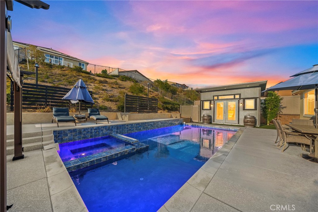 POOL HOME tucked inside the exclusive gated community of Nicolas Heights in the heart of Temecula. This beautifully designed 4-bedroom, 4-bathroom home spans 2,500 square feet and effortlessly blends high-end style with everyday comfort. Every detail has been carefully thought out to give the space a polished yet welcoming feel. The open-concept floor plan is perfect for both quiet evenings at home and lively gatherings. The spacious dining room is ready to host your holiday dinners or casual weekend brunches. In the kitchen, you'll find a chef’s dream setup with a large quartz island, stainless steel appliances—all opening to the living area where oversized pocket sliding glass doors open the interior to the California patio room. Out back, you will find an added room currently used as an office but would make a great pool house or guest room. The covered patio is made for relaxing or entertaining, offering that seamless indoor-outdoor lifestyle Southern California is known for. Whether you're sipping your morning coffee or enjoying an evening glass of wine, this backyard setup is the perfect spot. The primary suite is its own little retreat—plenty of space, a large walk-in closet, and a spa-like bathroom with a soaking tub and separate shower. You’ll also enjoy practical touches throughout the home like an indoor laundry room with tons of storage. Plus, with leased solar panels, you can feel good about energy efficiency too. And let’s not forget the unbeatable Temecula location. From award-winning wineries and charming Old Town to hiking trails, golf courses, parks, and hot air balloon rides, the local lifestyle is all about enjoying the best of Southern California. If you’re looking for luxury, comfort, and a community that feels like home—this is it. Welcome to Mulberry Ct. You’re going to love it here.**Solar on Lease to be transferred to Buyer.