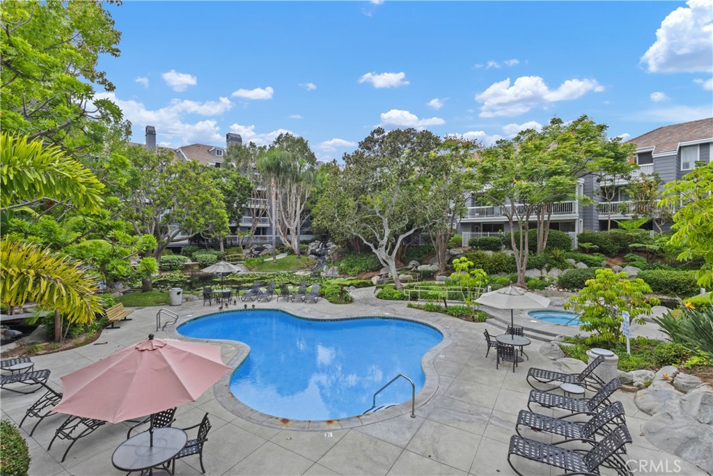 Experience resort-style living just minutes from the beach in this beautifully upgraded 2 bedroom, 2 bath condo at Seabridge Villas. Situated on the 3rd floor with convenient elevator access, this light-filled home offers an open and functional layout, perfect for both everyday living and entertaining. The remodeled kitchen features granite countertops, stainless steel appliances, upgraded cabinetry, and a breakfast bar that flows seamlessly into the dining area and living room, complete with a cozy fireplace. Sliding glass doors open to your private balcony overlooking the tropical pool, lush landscaping, and serene waterfalls—your own peaceful retreat. The spacious primary suite offers two mirrored closets, direct access to the balcony, and an en suite bath for a private sanctuary. The secondary bedroom is equally roomy, boasting a walk-in closet plus a mirrored closet and easy access to the hall bathroom. Additional highlights include recessed lighting, ceiling fans, indoor laundry, and two assigned parking spaces. Seabridge Villas is a gated, guard-secured community offering exceptional amenities: two pools, hot tubs, tennis courts, a fitness center, sauna, clubhouse, and miles of meandering streams and walkways shaded by mature trees. With top-rated schools nearby and Main Street, Pacific City, and the Huntington Beach Pier just a bike ride away, this condo combines everyday convenience with the ultimate coastal lifestyle.