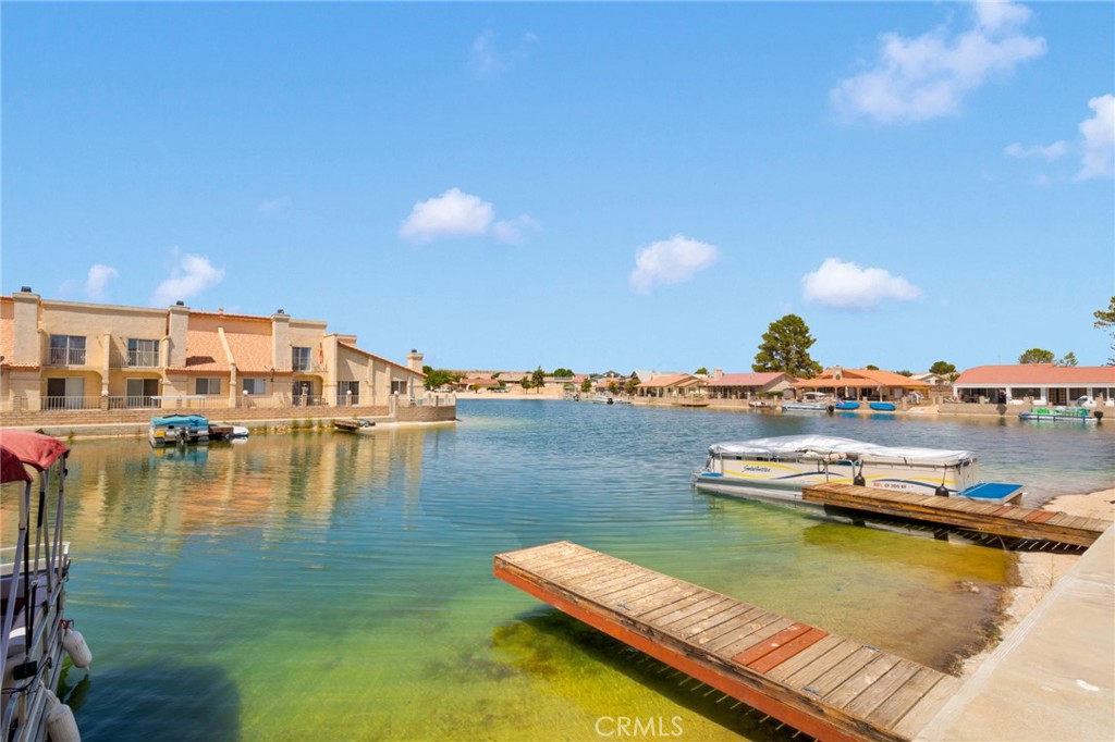 Enjoy lake living in this 2 bedroom, 1.5 bath, 2-story condo with 1,073 sq ft of charm. Featuring an attached garage, private front courtyard, and peaceful back patio perfect for soaking in serene sunsets, plus your own boat dock just steps away! Ideal for morning paddle sessions or cruising on the lake. Inside, you’ll find an easy-flow and open concept layout perfect for relaxing or entertaining. This home offers comfort, convenience, and plenty of potential in a prime lakefront setting. This is the perfect opportunity to own a lakefront home in Silver Lakes. Whether you're looking for a full-time residence or weekend retreat, this one’s got the vibe and the value.