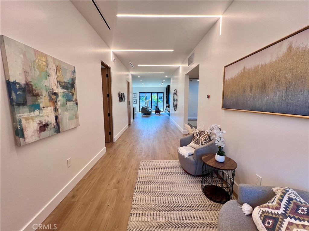 This beautifully crafted 3-bedroom, 2-bathroom main home is newly built last year and set on a quiet, tree-lined street in the heart of Reseda. As you enter, you’re welcomed by soaring ceilings and thoughtfully designed LED lighting that adds a modern touch while enhancing the home’s sense of openness, light, and volume. Clean architectural lines, abundant natural light, and custom, high-end materials create a warm yet elevated atmosphere that instantly feels like home.
The open-concept layout flows seamlessly from the living area to the gourmet kitchen, which features top-of-the-line stainless steel appliances, sleek cabinetry, and elegant finishes—ideal for both everyday living and entertaining. Oversized windows frame views of the beautifully landscaped yard, bringing the outdoors in and filling the home with a calm, airy energy.
Each bedroom offers generous space and comfort, while the two bathrooms are designed with style and function in mind. A dedicated laundry room provides added convenience, and all kitchen appliances are included. Every detail of this brand-new home has been curated for comfort, beauty, and ease. Sophisticated yet welcoming, this home is ready for someone to make it their own.