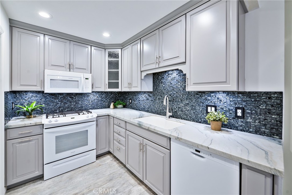 Gorgeous Anaheim Hills condo! Beautifully remodeled kitchen with granite counter, tile backsplash and newer appliances. Wood look laminate flooring and wood look tile flooring throughout. Upstairs bathroom completely updated, cabinets and counter. Great inside tract location next to a greenbelt. Covered patio large enough for entertaining family and friends. Walking distance to shopping and dining.