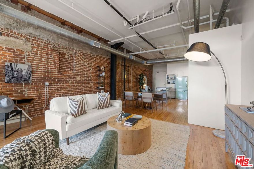 Step into a piece of Los Angeles history at the iconic Molino Street Lofts, located in the heart of the city's original Arts District. Crafted from 1920s warehouse buildings, this beautifully repurposed space embodies authentic industrial architecture  exposed brick walls, soaring ceilings, and streams of natural light. This sophisticated studio loft offers a seamless blend of historic character and modern convenience. The open floor plan allows for flexible living, whether you're designing your ideal creative workspace, photography studio, or serene private retreat. The kitchen pairs classic style with contemporary function, featuring stainless steel appliances and a retro-inspired Big Chill refrigerator  a perfect nod to the building's vintage roots. Polished hardwood floors and exposed brick from floor to ceiling a warm and inviting atmosphere. Enjoy thoughtful upgrades like a water filtration system, in-unit laundry, and more. Residents of Molino Street Lofts enjoy rooftop decks with sweeping views of the Fourth Street Bridge and DTLA skyline, a fitness center, and secured parking. Outside your door lies one of L.A.'s most vibrant neighborhoods  a community alive with art galleries, boutique shops, dog parks, and some of the city's best restaurants and coffee houses. A space where heritage meets creativity and Downtown energy meets tranquility.