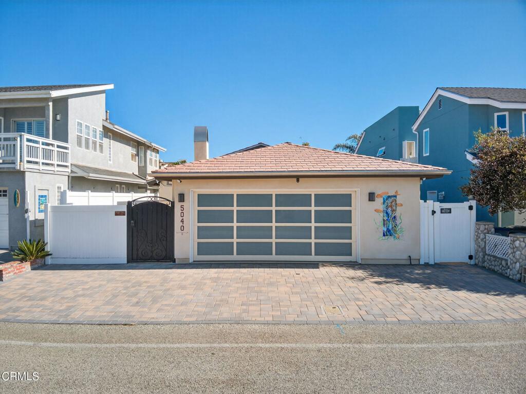 Coastal living at its finest! One block from the sand, this beautifully remodeled single-story beach home is chock-full of tasteful and convenient upgrades! Thoughtfully designed with an open-concept layout, the spacious kitchen, living, and dining areas are bathed in natural light from skylights above, creating a bright and inviting atmosphere. The beautiful chef's kitchen features top-of-the-line appliances, sleek finishes, and a seamless flow for effortless entertaining. The stunning quartzite countertops compliment the stylish cabinetry and the Subzero refrigerator, wine refrigerator, Viking stove and microwave drawer, offer the perfect set up for a delicious home cooked meal. With two bedrooms and two amazing bathrooms, this home is ideal as a full-time residence, weekend retreat, or vacation rental. Step outside to the private patio and enjoy cozy evenings around the fire pit the perfect place to unwind after a day at the beach. Located in the desirable Oxnard Shores community, this home is just steps away from an expansive sandy beach, ocean breezes, and the laid-back coastal lifestyle you've been dreaming of. Don't miss your chance to own this turnkey beachside gem!