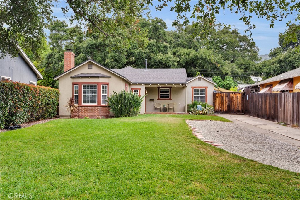 Back on the market at no fault of the seller. Don't miss your chance to own this move-in ready gem! This welcoming traditional home sits on a lovely tree-lined street and a short 3-minute walk to the park. It is also minutes away from historic Monrovia where they have first Friday events that feature a farmers’ market, crafts, and events for all ages. The home enjoys a comfortable and functional floor plan. The spacious living room features a custom tiled fireplace, rich tile flooring, recessed lighting, and the windows allow massive natural light to bathe the home. The living room flows into a generous dining area perfect for gatherings. The updated kitchen features plenty of storage, a pantry, a built-in wine fridge and a breakfast nook. From the kitchen you have access to the well-manicured, low-maintenance private backyard. A spacious bathroom with dual sinks, new tub surround and tub, sits conveniently between two bedrooms, one of which has French doors leading to the serene backyard, while the other offers a walk-in closet. Those working from home or desiring their own quiet space or a guest room, will find a cozy flex room off the backyard. The home also has an enclosed laundry area, and a new, large storage shed. With a newer roof, and an expansive front yard that offers ample parking and plenty of gardening space, this home is delightful and airy. Motivated seller open to working with buyers and their lender on a temporary rate buy-down to help reduce monthly payments.