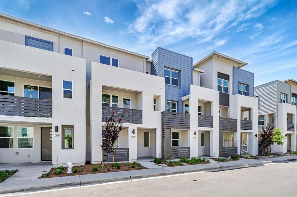 This Towns Plan 1 home at City Village by SummerHill Homes is available for quick move-in and features 3 bedrooms, 3.5 bathrooms, a 2-car side-by-side garage, quartz countertops, Bosch stainless steel appliances, and a deck off the family room. The first floor includes a bedroom with a private bath perfect for guests or as an office. Both the primary and secondary bedrooms offer spacious walk-in closets, and energy-efficient Solar panels can be leased or owned. City Village offers 404 stylish residences and a 2-acre public park with biking and walking paths, seating areas, and a shared community BBQ. Located near San Ramons City Walk neighborhood, the community is within walking distance to City Centers restaurants, shops, and theaters, with easy access to schools, work, and public transit. Nearby attractions include City Center Restaurants & Retail, Bridges Golf Club, and the Iron Horse Trail. Please note: the exterior image shows the model home; interior photos are of a model home.