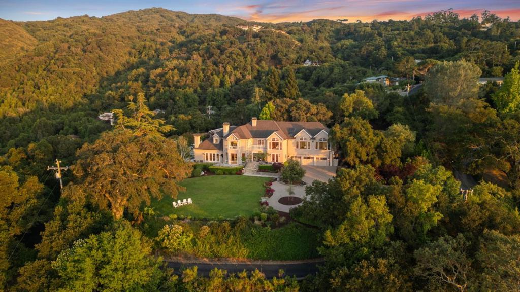 Chateau De La Vue - Elevated above Los Gatos, boasts over 9,500 sq. ft. of living space and presides over an ultra-private 2-acre estate where panoramic 180° views stretch from the lights of Silicon Valley to the skyline of San Francisco. This dual-gated compound offers an unmatched blend of security, tranquility, and architectural significance just minutes from downtown Los Gatos. The main residence spans over 7,000 sq. ft. with 4 bedrooms accompanied by 5 bathrooms and an executive office. The interior balances timeless luxury with dramatic indoor-outdoor flow, creating seamless entertaining experiences across expansive terraces, views, and landscaped grounds. A separate, over 2,200 sq. ft. guest house, accessed via its own gated driveway delivers full dual-living flexibility across two levels, each with its own kitchen, accompanied by 1 bedroom and 3 bathrooms. Ideal for multigenerational living or a private retreat. Resort-style amenities include a 75-foot lap pool and spa, movie theater, gym, and oversized 3-car garage.. Modern regulations make replication of an estate of this size, above ground, virtually impossible today. Chateau De La Vue is a generational opportunity to own one of Silicon Valleys most iconic, irreplaceable estates!