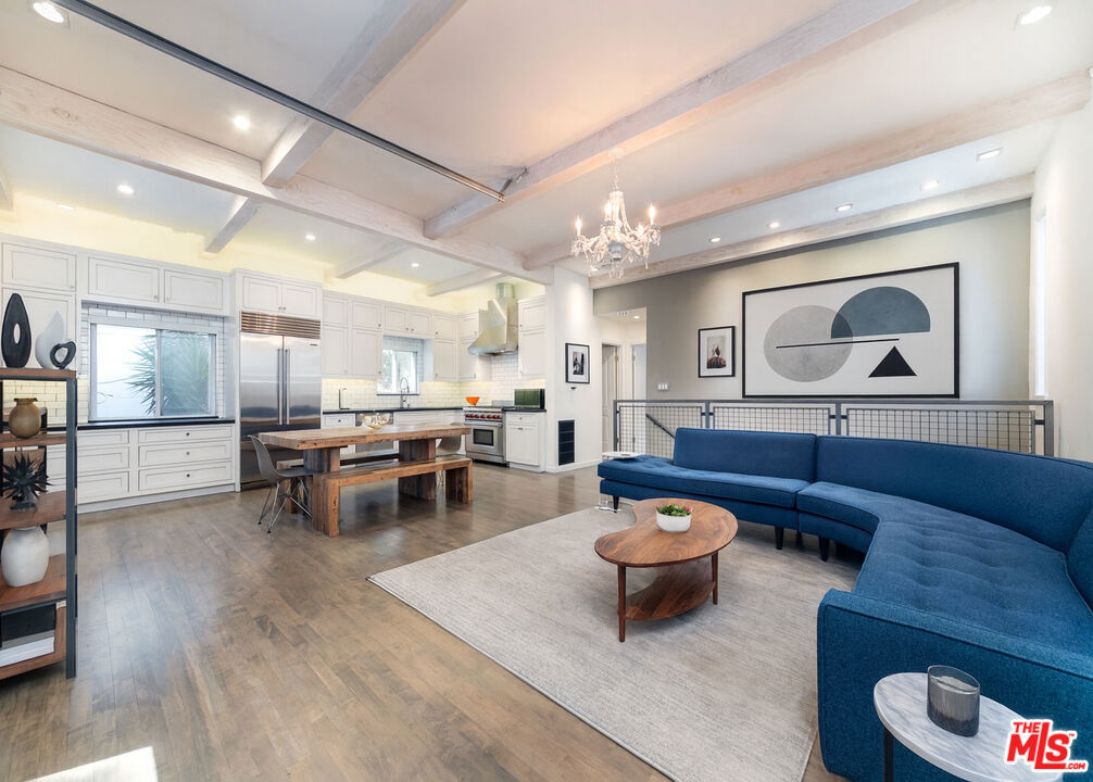 Extraordinary postmodern organic Laurel Canyon loft style home with a Dream Kitchen designed by a Top Chef Winner, Celebrity Chef, and Star Restaurateur! -- All this with built in Airbnb short rental income potential to cover half your mortgage or more! This cool cooking oasis is set on a verdant hillside lot, with a high beamed ceiling, open concept layout, that creates a seamless indoor and outdoor space for you to express your culinary game, and enjoy the fresh air and lifestyle the Hollywood Hills West has to offer, and also be a part of it! Just a 9 minute stroll to local favorites like the Country Store or Pace or the Cleaners, or a 4 minute drive to the Sunset Strip, this unique haven in this iconic neighborhood is a masterpiece of artistic expression--with a major remodel conducted by this famed Culinary Artist circa 2015, including the literally Celebrity Chef's kitchen featuring high end stainless steel appliances: Subzero refrigerator, Wolf stove, industrial grade hood, supple soapstone countertops, floor to ceiling custom cabinets, with abundant natural light and recessed lighting. While a simple exterior directs you upstairs, the Top Floor opens you up to a whole new realm of creative possibilities with this open and light-filled space encompassing this Kitchen and Living and Dining areas, with an Office Nook and adjacent Powder Room--perfect to entertain your guests--ready for your personal touches and creations, relaxation, and enjoyment. This Focal Point of the home is flanked on one side by a wide open roll up doorway to the Outside Deck with Dining and Conversation areas, converging with an easy maintenance succulent garden topped by native plants and fauna frequented by some wondrous wildlife. And on the other side, a blissful Primary Suite: a spacious Primary Bedroom with closet space all along one wall, and En Suite Bathroom with double sinks, walk in rain shower, and another closet--a walk in closet, with empty shelves, ready for your wardrobe. This Top Floor is simply and elegantly laid out with its Focal Point, to maximize space and connection to nature and provide for all of your practical living and needs! While downstairs, the large Second Bedroom is where you can let the rest of your imagination go wild--this oversized flex space can be used as a traditional bedroom, guest suite, home gym, entertainment room, office workspace, or creative studio--for writing, music production, or editing--the possibilities are endless! Plus, with its own En Suite Bathroom with full bathtub, and separate Private Entrance that comes around the outside of the home, through a large Covered Patio, this Second Bedroom can be perfect for a home based business where clients might visit, or for income potential as a single apartment for long term stay or a short term rental on Airbnb, with its own separate entrance and outdoor space! That can be used to subsidize potentially half of your mortgage payment, as if your home were a Duplex income property. To round it off, downstairs on the front side, a generously sized 2 Car Garage provides direct secure access to the home, with relatively small slope to entrance from the street--so you won't scrape the bottom of your sports car, or low rider! This 2 Car Garage can fit 2 normal mid-size cars comfortably, and still have space to move around to access the included stacked washer and dryer, storage cabinets and shelves, and A/C and plumbing systems. With easy access to Hollywood, the Valley, or the Westside, this home is in the middle of all the action, yet it's tucked away like a hillside retreat, a wonderful house you can call your home, in the highly rated Wonderland Elementary School District. Available furnished or unfurnished, it's also incredibly convenient and turnkey, ready for you to move right in. Come take a look, you've got to see this amazing retreat, and gem of an asset, that's ready for your vision!