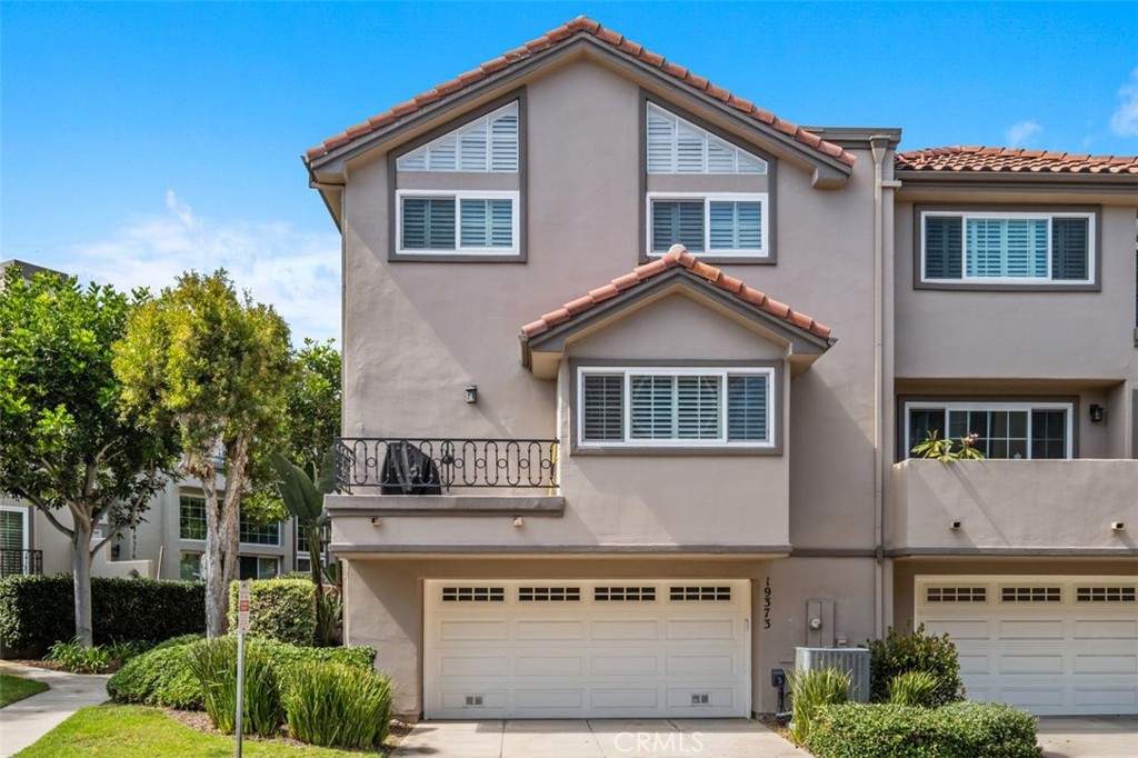 Seize the opportunity to live in one of the most prestigious communities in Huntington Beach. This interior END-UNIT sits in a quiet location and is within the prestigious ocean-close, guard-gated community of SeaCliff on the Greens. This spacious 2,236 SF townhome offers the best of coastal living. Step through the expansive WRAPAROUND PATIO into a bright and inviting living room with soaring vaulted ceilings, a cozy fireplace, and dramatic floor-to-ceiling windows accented with plantation shutters, glass door built in cabinet & wine rack. The open-concept dining area flows effortlessly into a beautifully designed kitchen with granite counters, Bosch and GE appliances and electric blinds at the patio door and kitchen, complete with a breakfast bar, and an adjoining family room ideal for everyday living and entertaining. Upgrades include new AC, a new updated electrical panel, a new roof, newer windows except in the living room and two remodeled bathrooms. The upstairs features a large family room which can be converted to a 3 bedroom. The oversized master has a private balcony, a huge walk-in closet and a remodeled bathroom with dual sinks and separate soaking tub. 2nd bedroom also features a remodeled guest bath. The oversized 2-car garage features a work table with built-in cabinets & drawers. There is also a separate household storage area with built-in shelves behind sliding doors. A real plus is extra parking next door for your out-of-town guests. Seacliff provides access to multiple pool and spa areas and main clubhouse in this exquisitely landscaped community. This home is also located in the award-winning Seacliff Elementary School District and is a quick stroll to the Huntington Club for a round of golf, pickleball or tennis. A short 9-minute walk to the beach, Dog Park or ride your bike downtown!