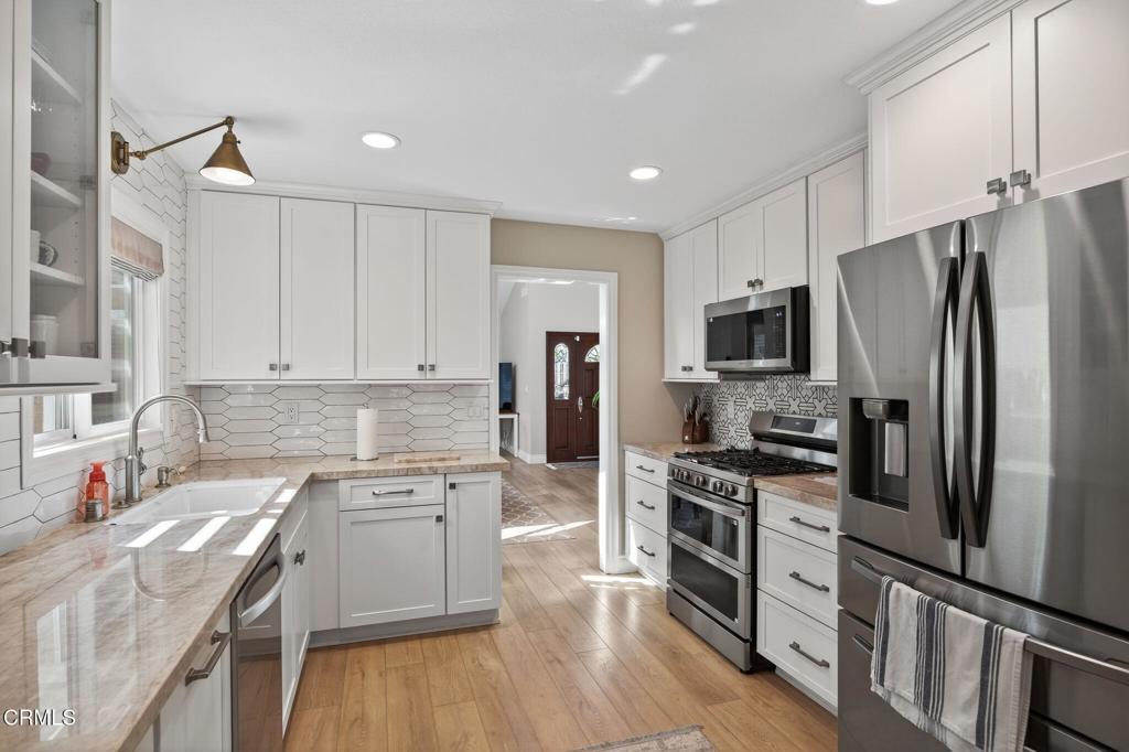 RV PARKING AND NO HOA - Looking for the perfect Rental? Welcome to 863 Tupelo Wood!This stunning 4-bedroom, 2 3/4-bathrooms residence in the highly desirable Wilshire Manor neighborhood blends comfort, style, and function into one perfect package. From the moment you step inside, soaring two-story ceilings flood the living and dining space with natural light, creating an open and airy atmosphere that feels both grand and inviting.At the heart of the home is a beautifully remodeled kitchen with sleek stainless steel appliances, solid surface counters, and a designer tile backsplash. Whether you're enjoying casual breakfasts or gathering with loved ones in the adjoining family room, every detail has been designed for easy living and effortless entertaining.This flexible floorplan includes the desirable downstairs bedroom with a fully remodeled bath--ideal for guests, in-laws, and grandparents. Upstairs, the spacious primary suite is a private retreat with custom built-ins, a remodeled spa-inspired bathroom, and plenty of closet space. Two additional bedrooms and another full bath complete the second floor.Step outside to your backyard oasis! The large grassy area for play, and a covered patio for barbecues and summer parties make it the ultimate gathering spot. With gated RV access, a 3-car garage, and newer dual-pane windows, this home truly checks every box.Best of all, you'll enjoy one of the most convenient locations in the Conejo Valley--close to hiking trails, parks, top-rated schools, shopping, and dining. No HOA - just pure California living at its finest!Don't miss your chance to make this move-in now.