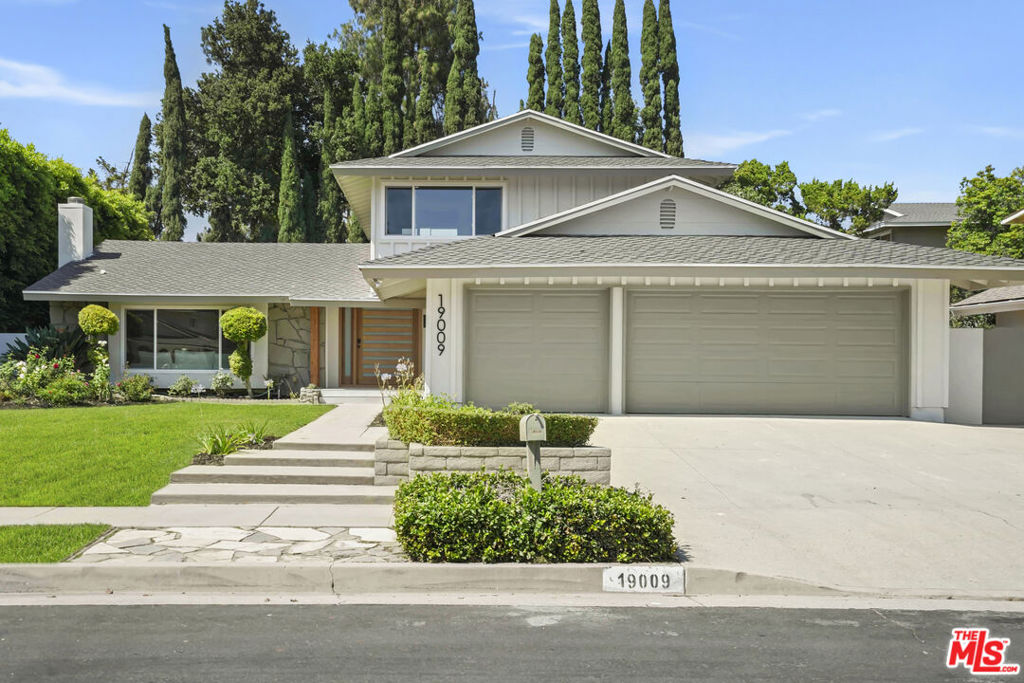 Tucked away in a peaceful neighborhood, this beautifully remodeled residence blends timeless charm with modern comforts in one of the area's most desirable neighborhoods. Recent upgrades include a brand-new kitchen and bathrooms, fresh interior paint, and stylish new flooring throughout. The flexible layout is both functional and inviting, featuring a spacious primary suite on the lower level, a cozy family room, and an expansive living room centered around a striking mid-century fireplace. The home feels grand yet warm, offering an ideal balance for both everyday living and entertaining. The kitchen is a true showstopper, equipped with an island, brand-new appliances, and an adjoining dining room that creates a seamless flow for hosting and gathering. Step outside to a private backyard oasis with a lush lawn, fruitful lemon trees, a generous side yard, perfect for weekend barbecues or peaceful mornings in the sun. Located near top-rated schools, including Beckford, Nobel, and Granada Hills Charter, and just minutes from the new Vineyards shopping center and Porter Ranch Park, this home offers the complete package of lifestyle, comfort, and location.