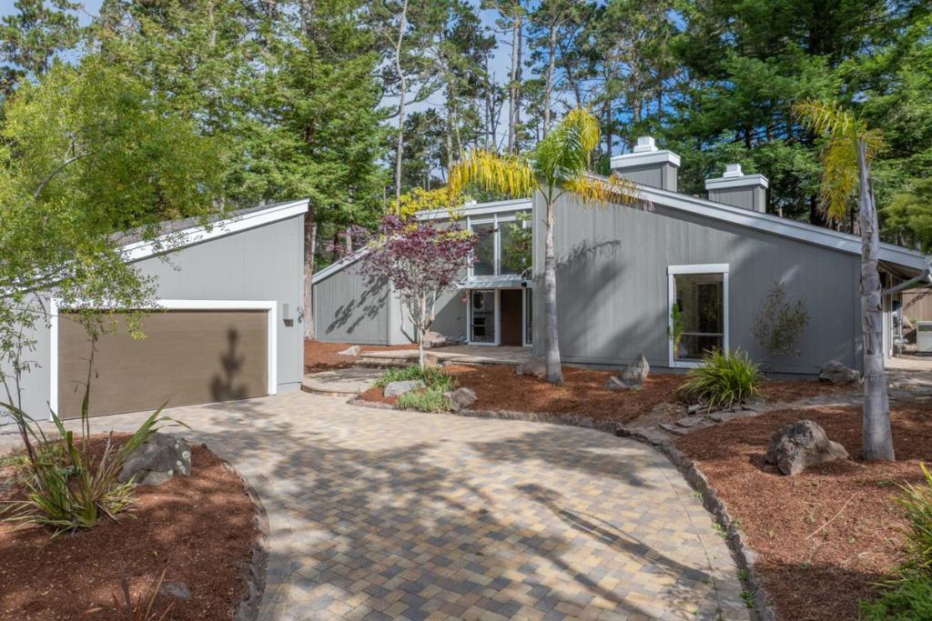 Tucked away on a quiet cul-de-sac in the sought-after Sunridge Pines neighborhood of Pebble Beach, this serene single-level retreat is nestled among the majestic trees of Del Monte Forest. Thoughtfully designed with vaulted ceilings and abundant natural light, the home offers a seamless blend of comfort, privacy, and convenience. Two spacious bedrooms each feature ensuite bathrooms and their own cozy fireplaces perfect for peaceful mornings or winding down in the evenings. The open layout enhances the sense of space, while large windows invite the outdoors in. A third bedroom option, currently staged as an office, offers versatility for remote work, hosting guests, or additional living space. A detached two-car garage provides ample storage and parking, and the home's tranquil setting offers the perfect escape all just minutes from world-renowned Pebble Beach Golf Links, upscale dining, boutique shopping, and the coastal charm of Carmel, Monterey, and Pacific Grove.