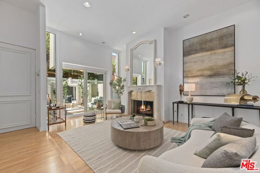 Located in the heart of Beverly Hills, adjacent to world famous Rodeo Drive, this bright and elegant three-bedroom, three-bathroom home embodies luxury living and all convenience. Surrounded by fine dining, world-class shopping, top rated schools, beautiful parks, and charming cafes, it offers an unmatched walkable lifestyle in one of the city's most desirable neighborhoods. No steps at front door entry lead directly into a spacious living room with high ceiling and fireplace, which connects seamlessly to a private outdoor courtyard perfect for entertaining or quiet relaxation. The primary suite includes its own fireplace and private balcony access, creating a tranquil retreat filled with natural light. Designed for comfort, accessibility, and sophistication, this home captures the essence of Beverly Hills living, offering a rare blend of charm, location, and timeless elegance all just steps from the best of the city. Easy to show. Call Moji Hakim 310-387-8500