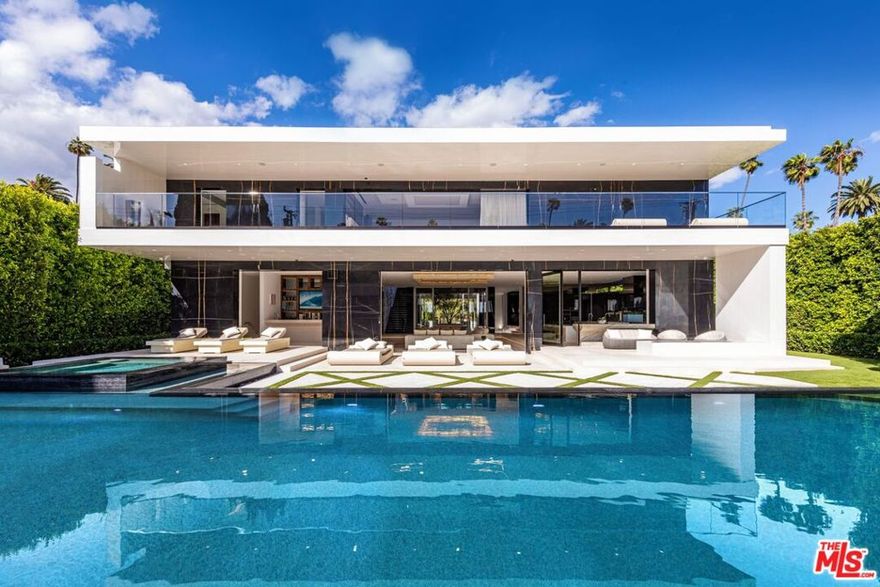 One-of-a-kind modern in the highly coveted Flats of Beverly Hills, blocks from the most iconic shops, restaurants & entertainment. Experience the pinnacle of modern design combined w/the highest standard in luxury living. The only budget was that there was no budget, it had to be the absolute best. The estate sets a new precedent of quality & beauty combining global materials w/iconic name brands. Encased in glass and marble, the home spans 16,450SF w/6 beds, 10 baths & guest house. Features include a serene, central courtyard w/olive tree & glass doors, hidden theater behind mahogany bookcase, Fendi kitchen, expansive master w/dual baths & closets, Techno gym, Alaskan Cedar finish wellness room w/sauna, open-air lounge w/glass front spa, expansive pool w/swim-up bar, 7 car garage w/turntable & 88' wall animation, walnut doors, hand-selected Antolini marble, stainless steel dual-gate entry, Pro Audio surround sound, Delos wellness system (air, water & light), Security Tech, Lutron/Crestron tech, starlight quartzite driveway & more. 3 levels of seamless indoor/outdoor living set within the 3 most coveted walking blocks in the Flats of Beverly Hills; Rodeo, Beverly & Canon Dr. Boasting the finest stones & exotic woods throughout including the Antolini & a burl wood kitchen by Fendi. Top of the line AV, LED high-def walls for watching movies. There has never been a home in the flats so dialed in w/all the latest & greatest amenities. Words cannot describe this modern architecture. There are a very rare 35 lots only on Canon and Beverly that were almost double the size so that buyers who waned to be able to walk to the shops and restaurants of Beverly Hills yet wanted the huge lots offered only in the 700 through 1000 blocks, could have the best of both worlds. These rare lots never come for sale. Come see it before it's gone.