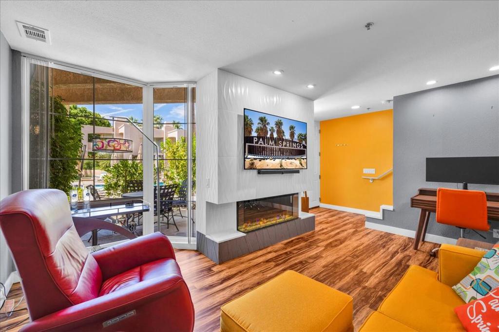 Welcome to Desert Sun Condos! This resort-style community offers beautifully landscaped grounds, a stunning saltwater pool and a relaxing spa. Conveniently located near downtown, the art district, shopping, nightlife, and top restaurants, you'll also have easy access to the Aerial Tram, casino, and airport. This fully remodeled condo features luxury vinyl flooring, quartz countertops, custom closet storage, Big Chill appliances, and a state-of-the-art Dimplex Ignite XL Bold electric fireplace. The half bath has been converted into a pantry but can easily be restored. Located within an inviting Au Naturalist community, it provides a relaxed and welcoming atmosphere for like-minded residents. Sold furnished (check with your agent about the list)--just bring your clothes and toothbrush! All information is deemed reliable but not guaranteed. Buyer(s) to verify independently.