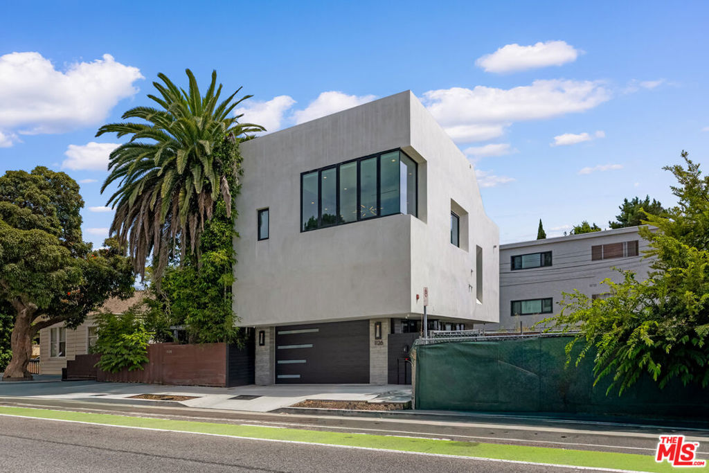 Stunning new construction home in the Heart of Santa Monica. Designed by acclaimed architect Dennis Gibbens, this brand-new 4 bedroom, 4.5 bath residence combines striking modern architecture with functionality. Fully gated with a secure entry and private direct-access garage, the home offers complete privacy while sitting just moments from the best of Santa Monica. The showpiece of the property is the spectacular 900 SF private rooftop deck, featuring panoramic views and every amenity for entertaining: a full outdoor kitchen with built-in BBQ, beverage fridge, beer tap, gas heater, outdoor dining and multiple lounge areas. Inside, soaring ceilings and walls of glass create a bright, open floor plan. The custom gourmet kitchen boasts top-of-the-line JennAir appliances, an oversized island with seating and abundant storage. The primary suite is a true retreat with a spa-like bath featuring an oversized shower and heated floors. A separate lower-level includes a spacious family room and two additional bedroom suites. This smart home is outfitted with Crestron automation, exterior security cameras, whole-house audio, electronic window shades, three Samsung Frame TVs and included high-speed internet service. Additional features include a private elevator to all levels, fast electric car charging and a cutting-edge rotating garage carousel for forward-street exit. A rare architectural offering with the very latest home automation amenities. Move-in ready October 21st.