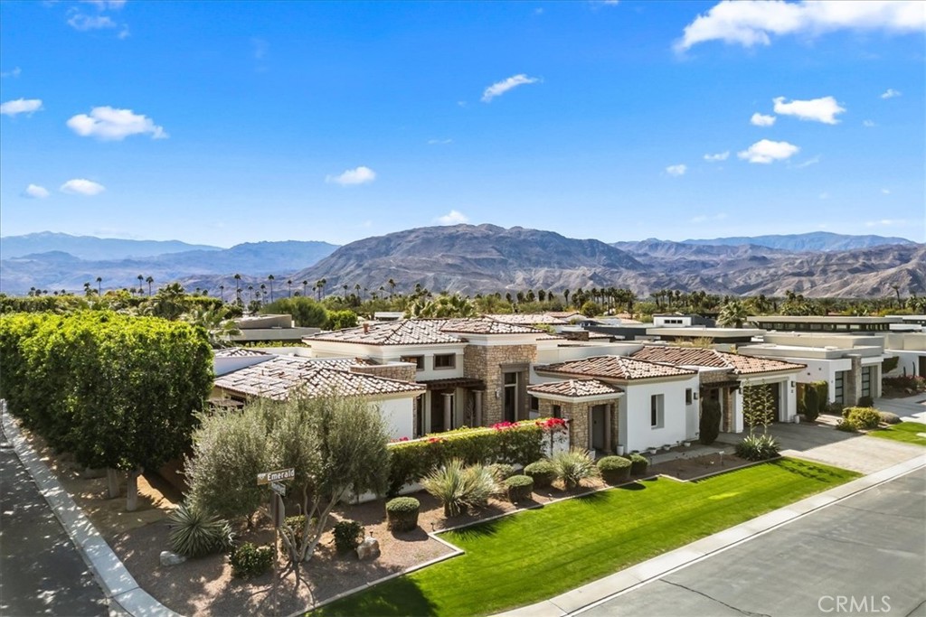 A rare opportunity to own your dream retreat in one of the most prestigious gated communities in Rancho Mirage at REVELLE AT CLANCY LANE. Originally the Phase 1 show model, this contemporary masterpiece spans 4,088 sq. ft. and offers an unparalleled blend of modern elegance and desert luxury. Step through a private courtyard with a decorative fountain into an open-concept living space with soaring ceilings, clerestory windows, and abundant natural light—perfect for relaxation and entertaining. The chef’s kitchen is a culinary delight, featuring a 13-foot island with a stunning embossed leather quartz countertop, top-of-the-line WOLF & SUB-ZERO appliances, and a spacious seating area. The primary suite is a true sanctuary with generous walk-in closets, a spa-like en suite with dual walk-in showers, and a deep soaking tub. Each of the three spacious bedrooms boasts its own en suite bath for ultimate privacy and convenience, all upgraded with remote motorized blinds. This exceptional home also includes a versatile office/media room with a built-in wet bar, easily convertible into a fourth bedroom, or a private guest suite with its own entrance. Experience seamless indoor-outdoor living with expansive glass walls that open to your private backyard oasis, where breathtaking mountain views set the backdrop for a sparkling pool, spa, fire pit, and lush landscaping—all designed for complete privacy and tranquility. Additional highlights include a three-car garage with built-in storage and additional driveway parking, a laundry room with ample storage and included washer and dryer, and a state-of-the-art Nest system for climate control. With fully paid solar panels, enjoy energy efficiency with no electric bills. This home is the epitome of luxury desert living— close to world class golf courses, fine dining, shopping and entertainment. Schedule your exclusive tour today!