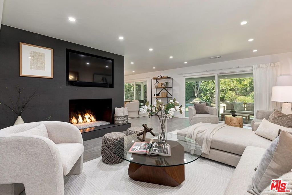 Welcome to 6101 Mary Ellen Ave, an exquisitely remodeled 3 Bed, 3 Bath plus Den family residence offering timeless elegance and modern comfort in the heart of Valley Glen. This spacious home is designed with an open-concept floor plan that effortlessly connects the kitchen, dining, and living areas, creating the perfect environment for both intimate gatherings and relaxed everyday living. The kitchen is a true highlight, featuring newly updated cabinetry, sleek modern appliances, and a large island that serves as both a functional workspace and a central hub for gathering and entertaining. A beautiful modern fireplace adds warmth and ambiance to the living area, making it the ideal place to unwind or host guests. A separate laundry room, beautifully appointed bathrooms; and a versatile den/office complete offering a private workspace or a peaceful retreat/bonus room that adapts to your lifestyle. Step outside to your private under roof terrace & tranquil yard - an expansive, lush backyard offering a well-manicured lawn, mature fruit trees, and an organic garden bed, perfect for those who appreciate the art of gardening or simply want to relax in a peaceful outdoor space. This home is ideally located just four houses from Valley Glen Park, offering the perfect blend of serene suburban living with proximity to the best of Los Angeles. Valley Glen is a charming, well-established neighborhood known for its quiet, tree-lined streets and a strong sense of community. The area is home to highly regarded schools such as Ulysses S. Grant High School, renowned for its Magnet and IB programs, along with excellent elementary schools like Erwin, Monlux, and Coldwater Canyon. For those seeking further educational opportunities, Los Angeles Valley College is just minutes away, offering a variety of cultural and academic programs. For those who enjoy an active lifestyle, Valley Glen Park is just steps away, with a dedicated play yard, walking paths, and a beautiful butterfly garden. The Tujunga Greenway, located nearby, provides a peaceful bike trail that connects to the Orange Line busway, offering easy access to public transportation while allowing for quiet, outdoor exploration. Valley Glen provides a refined, tranquil environment while offering exceptional connectivity to the rest of Los Angeles. With easy access to the 170 and 101 Freeways, this location offers quick access to North Hollywood, Studio City, and Sherman Oaks, with all of the area's finest dining, shopping, and entertainment options just minutes away. Public transportation is also readily available via LA Metro and the Orange Line busway. 6101 Mary Ellen Ave is an exceptional location and home designed for those who appreciate both convenience, elegance and comfort. This is more than just a place to live it's a sanctuary where you can enjoy the best of Valley Glen. Schedule your private tour today and experience firsthand the lifestyle that awaits.