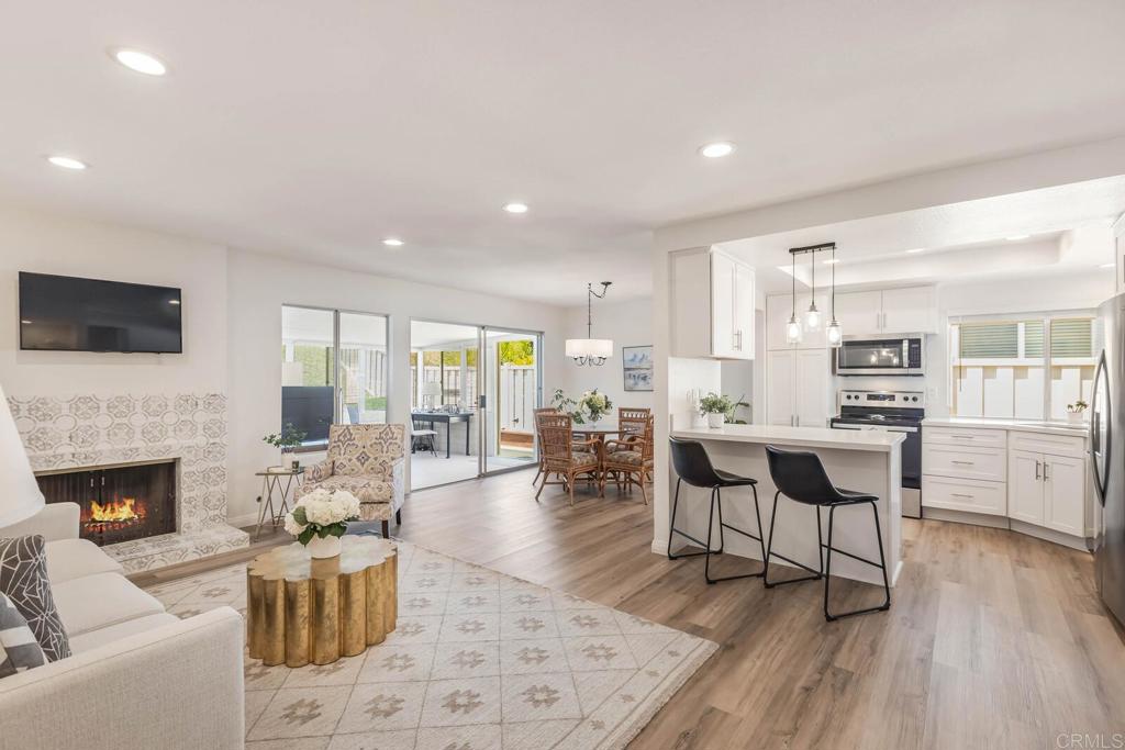 Step into this beautifully updated single-story home where modern style meets everyday comfort. Featuring 2 spacious bedrooms and 2 full baths, this residence has been thoughtfully renovated with quartz countertops, sleek new fixtures, and luxury vinyl plank flooring throughout, offering both elegance and durability. Flooded with light, the open-concept layout flows seamlessly. With an additional 260 square feet in the enclosed sunroom, there's plenty of space perfect for a cozy TV room, home office, exercise space, or crraft studio. Whether you’re relaxing indoors or entertaining guests, the home feels bright, airy, and welcoming from the moment you walk in. From this desireable interior community location, enjoy the lovely private park, and a short walk to the clubhouse, tennis & pickleball courts, and heated community pool, spa, and sauna. Enjoy unbeatable convenience with popular retailers like Costco, Walmart, Kohl’s, Target, and Hobby Lobby just moments away, along with a nearby mall and movie theater for shopping and entertainment. You'll also find Scripps and Tri-City medical facilities close by, and the beach is only 10 minutes away, combining comfort, care, and coastal lifestyle in one ideal location. If you’re looking for move-in ready charm with tasteful upgrades and that hard-to-find single-story layout, this one is a must-see.