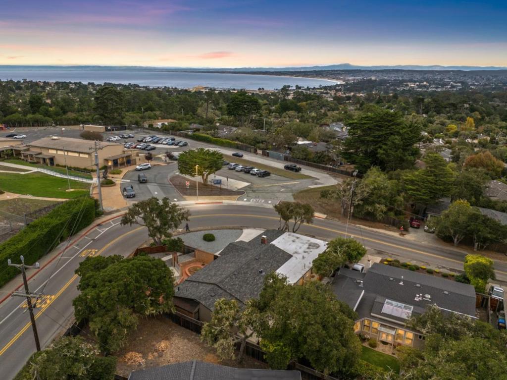 Superb Monte Regio 2,048sqft remodel located on an elevated 8,200sqft sweeping corner lot adjacent to open space and unobstructed ocean views with multi-directional natural light flow throughout the day. Thoughtfully finished with all new wide plank wood flooring, custom paint, generous open concept living/dining area with cozy fireplace, updated Chefs Stainless Kitchen with quartz counters, full backsplash, under cabinet lighting, water line for fridge and corner view breakfast nook with breakfast bar island. Off the breakfast nook is the laundry area with updated powder room. Generous primary suite with walkout garden access, atrium bathroom adjoined with a luxurious cedar walk-in changing room/closet. 3 large guest rooms including walkout garden access, custom tiled guest bathroom. New tankless water heater/furnace/200Amp service/fencing and epoxy garage flooring. Relax in your private and expansive west facing outdoor living space beautifully finished with extensive terraced brickwork and soothing ocean views. This compound style lot may have ADU possibilities. Convenient to vibrant Soledad & Del Monte shopping centers, Schools, Veterans Memorial Park, hiking trails, Pacific Grove, Via Paraiso Park, downtown Monterey restaurants, shops, entertainment and Downtown Carmel.