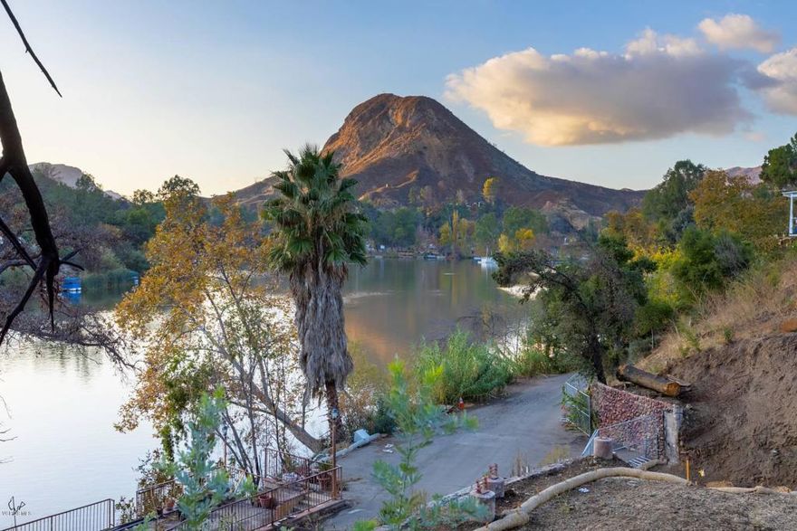 Amazing South facing view lot on Malibou Lake with plans for a 3623 sq ft home including basement. 3 Bedrooms, 3.5 bathrooms, 2 separate additional rooms/offices, gym & media room. Situated perfectly for incredible mountain, lake and sunset views w/multiple large decks & private dock site right out front. Members at Malibou Lake enjoy year round water fun from boating, fishing, swimming, paddle board, sailing. The club also features a beautiful clubhouse, swimming pool, tennis court and pickleball. Located within the Las Virgenes School District. MLMC has the fantastic parties, events, live bands and so much more. Close to beaches and conveniences. A special way of living. Plans available upon request. Seller will deliver final approvals and Buyer will pull permits in Buyer's name.