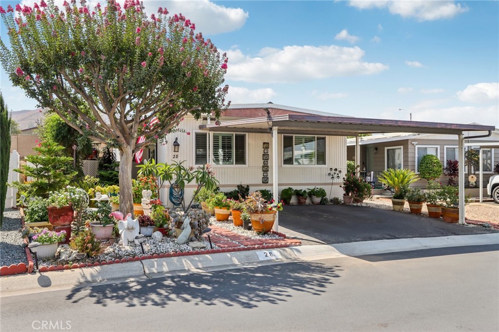 Step into affordability, comfort and convenience with this beautifully maintained and tastefully updated 3-bedroom, 2-bathroom home located in the highly desirable Mission Village Mobile Home Park—an inviting 55+ community ideally situated near the Corona border. Enjoy peaceful mountain views and easy access to Kaiser Permanente, Tyler Mall, Metrolink stations, and major freeways.
This home greets you with fantastic curb appeal, highlighted by lush, drought-tolerant landscaping filled with vibrant plants and succulents. A spacious, covered front porch provides the perfect setting to enjoy your morning coffee or unwind in the afternoon breeze.
Inside, you'll find a thoughtfully designed open floor plan with generously sized bedrooms and a primary suite featuring a walk-in shower, stylish granite countertops, an updated vanity, and modern fixtures. The home showcases elegant wood laminate and tile flooring throughout, blending warmth with durability.
The kitchen is open to a cozy family room and features granite countertops, classic subway tile backsplash, stainless steel appliances, and beautiful wood shutters throughout the home. A charming dining area includes a built-in china cabinet, offering both extra storage and a stylish place to display your favorite pieces.
Perfectly positioned within the community, this home offers added privacy while still being close to all of the neighborhood amenities. Mission Village offers resort-style living with a year-round heated pool, spa, outdoor shower area, fitness center, modern laundry facilities, a community lounge, and a clubhouse for resident events and social gatherings.
Pet-friendly and meticulously maintained, this peaceful park offers a relaxed yet connected lifestyle. Don’t miss your chance to enjoy affordable senior living with luxury amenities in one of Riverside’s most welcoming and vibrant 55+ communities!