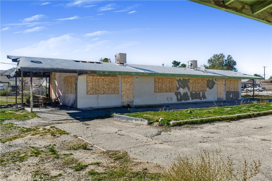 Major fixer - Property has existing building code violations and is currently boarded up. DO NOT WALK ON PROPERTY. Great opportunity on a huge lot in central Yucca Valley - perfect for builders, investors, or owner-users. The large lot provides flexible yard and parking options with room to add a pool, units, or reconfigure.  Huge value-add investment opportunity for rental income and/or potential to add additional units or redevelop (buyer to verify). Existing structure is 4 units across two detached buildings, totaling 2,850 SF with 8 beds, 4 baths on an expansive ±45,956 SF lot. Prime location just minutes from shops, restaurants, schools, and services along Twentynine Palms Highway and a short drive to Joshua Tree.