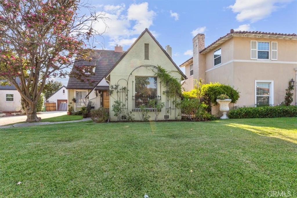 On a peaceful, tree-lined street, this 3-bed, 2-bath Tudor blends timeless character with modern upgrades. The bright living room features soaring ceilings, a cozy fireplace, and built-in speakers. A first-floor bedroom and full bath are perfect for guests or extended family.
The updated basement offers flexible space for a media room, home office, or gym. Enjoy original hardwood floors, custom cabinetry, and a sunny breakfast nook overlooking a backyard with mature fruit trees and blooming wisteria ideal for gardening and outdoor dining.
Close to top-rated schools, parks, markets, and a variety of dining options. A rare mix of charm, comfort, and convenience.