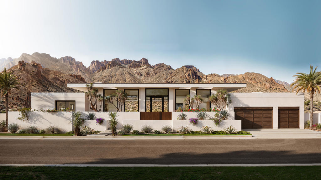 Located in the Flores Montanas community, this 4 bedroom 5 bathroom modern residence offers 4,474 sq ft of refined living. Soaring 14-ft ceilings and real white oak floors and cabinetry set the tone for sleek sophistication. The expansive great room opens seamlessly via automated pocket doors to a resort-style backyard with a knife-edge black pebble tech pool, an 11-ft fire feature with cascading waterfall, and built-in space heaters for year-round comfort.The sleek kitchen is equipped with Monogram appliances, double dishwashers, double sinks, and Taj Mahal natural stone countertops. Additional highlights include a spacious laundry room, double washers and dryers, and a fully insulated, air-conditioned 3-car garage with hot/cold water spigot and custom dog wash station.This fully automated smart home features whole-house reverse osmosis filtration, solar power, indoor/outdoor sound, and smart window tech in the primary bath. All within minutes of Old Town La Quinta's charming shops, dining, farmers markets, and world-class golf--offering the perfect blend of high design and desert lifestyle.