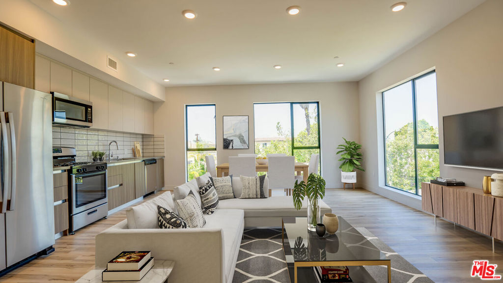 This beautiful 2 bedroom penthouse unit has west-facing views and a private balcony off the primary bedroom. Large windows in the living room allow plentiful sunlight. Open space living area, hardwood floors, central heating and cooling, and a modern kitchen with stainless steel appliances. This unit has 2 full bathrooms and an extra 1/2 bath for guests. In unit washer/dryer. Located near Beverlywood and Picfair Village. Close to Target, Sprouts, Trader Joe's, Beverly Center, and other retail stores. Easy access to the I-10 for commuting. Two parking spaces included. Some photos are virtually staged.