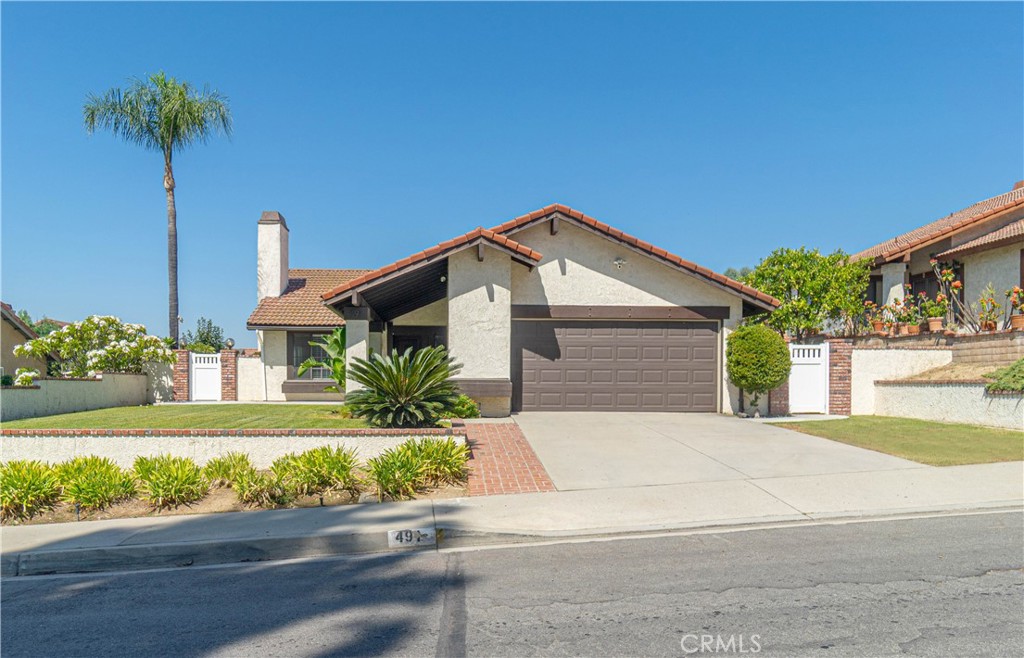 CONTEMPORARY UPGRADES!! This exceptional single-story home is located in a prime area along the foothills of Duarte, perfect for your active, fun-loving lifestyle! Enjoy inviting curb appeal with brick-lined hardscape, healthy front lawn and covered entryway. New custom wood front door features rustic style clavos and peep window. You can appreciate the open layout formal living and dining room with a toasty fireplace under a vaulted ceiling. The family room opens to the kitchen with granite counter tops, a breakfast bar, stainless steel appliances, two floating shelves, recessed lighting and a sliding glass door to the backyard. Extensive use of durable, attractive LVP flooring in the main living areas. Relax in the primary suite with a double door entryway and a swanky fully remodeled en suite bathroom with designer-inspired finishes, extra large custom shower niche and double sinks. Both bathrooms are gorgeous and the hallway bathroom has a quartz vanity! The laundry area offers hookups for both electric and gas clothes dryers. More upgraded items include a Nest® thermostat, water filtration system, 6 dual pane windows, ceiling fans in all bedrooms, efficient whole house fan, newer furnace and AC compressor, 200 amp electrical service, and an EV charging circuit in the garage. In the backyard, you have a concrete patio, raised garden bed and block walls. Enjoy the mountain view, too! We are conveniently located near Royal Oaks Park and Bike Trail, The Rancho Duarte Golf Course, Encanto Park, Azusa Wilderness Park, Chantry Flats for hiking trails and award winning Duarte Schools. Very commuter friendly near eateries, shopping and much more. Something for everyone!