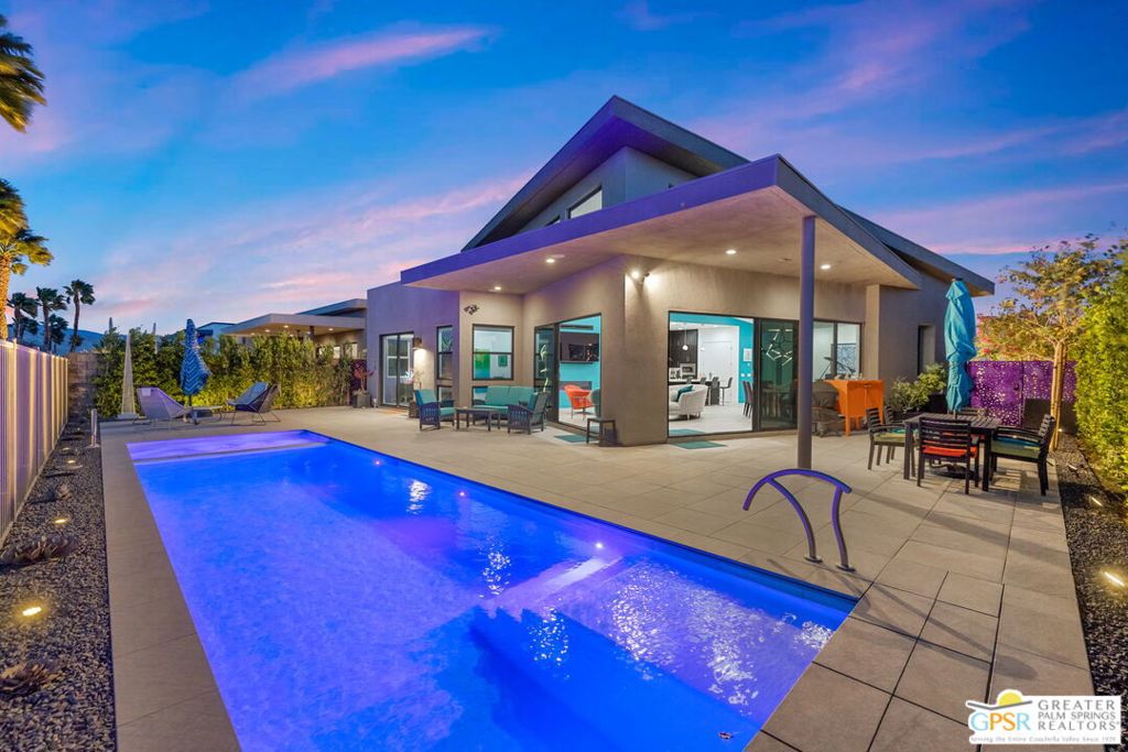 Located in the highly sought-after Escena Golf Club, this 3-bedroom, 3-bath, 2,593 sq ft home is a masterclass in contemporary design, comfort, and efficiency. Built in 2023 and elevated well beyond the builder's standard, this one-of-a-kind residence showcases custom upgrades, designer finishes, and bold artistic touches throughout. The open-concept layout features soaring ceilings, a showpiece kitchen with premium appliances, and a spacious great room framed by panoramic mountain and golf course views. Large sliders blur the lines between indoor and outdoor living, opening to a private west-facing patio with a sleek pool, the perfect sunset spot. Sustainability meets style with 18 owned solar panels and two battery storage backup systems, offering true peace of mind and energy efficiency year-round. The luxe primary suite, smart-home features, and low-maintenance desert landscaping add to the effortless lifestyle. Set behind the gates of Escena, enjoy access to a premier golf course, scenic walking paths, and a vibrant clubhouse with a renowned restaurant and bar just moments from your door.