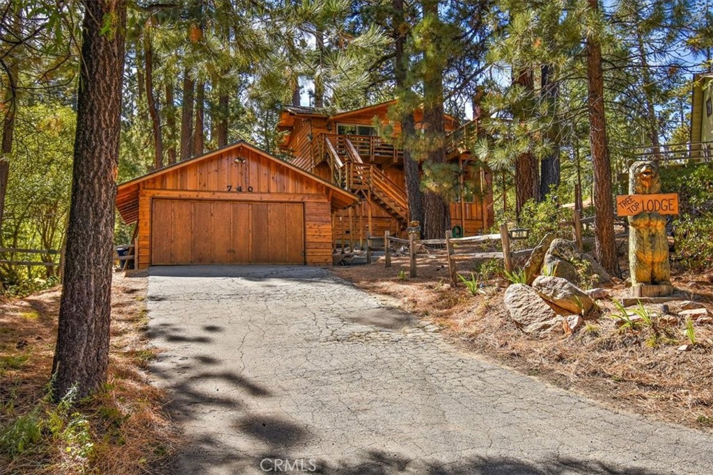 Premier location, lakeview, huge fenced in lot. 2-car garage plus room for 6 more in driveway. Lowest price in multi-mill $$ neighborhood, short walk to lake, hiking trails and Boulder Bay Park! Yard is perfect for snow play or relaxing in spa among mature trees, granite boulders and seasonal creek. Ground floor entrance to 3 sleeping areas- two large BRs (1 kg,1 qn) w/large closets/windows and multi-use room that sleeps 3 w/ closet, plus TV/ game room and a stone tiled full BA. Upstairs includes Great Room w/rock FP, dining area w/dual beverage centers and a full custom tiled BA. Updated kitchen w/granite counters, newer appliances and 10’ live edge bar surrounded by windows and stunning open beamed vaulted ceiling. Large lakeview deck accessed from GR and exterior stairs. All windows/10’ slider are newer dual paned, upgraded electrical and plumbing, new tankless WH and LED lighting. Pride of ownership, RV parking, upgraded baths and kitchen, huge deck and more. Just move in and enjoy.