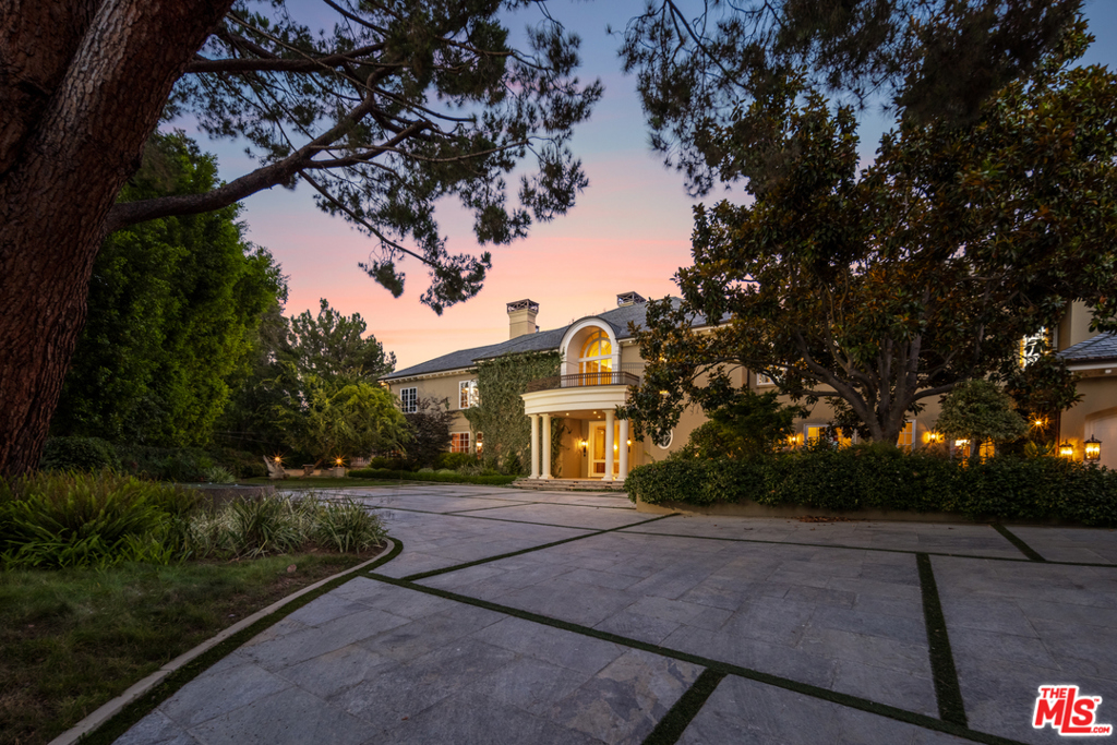 Located in the prestigious, guard-gated, celebrity enclave of Beverly Park South, this 13,500 sq ft Georgian estate is sited on just over 2 enchanting acres with breathtaking city and canyon views. Selected and built by the developer as his own personal residence, and equipped with every modern and luxury amenity imaginable, this exceedingly secure & private estate is one of only a few Beverly Park properties affording sweeping city lights views. Luxury living spaces include state of the art gym with steam room and sauna, plush movie theater, wood-paneled library, and Master Bedroom wing with dual bathrooms and closets. Designer details include artisan crown molding, parquet wood flooring, and high-end, imported materials. The verdant grounds include rolling lawns, sparkling pool and spa, & several "secret" gardens making this one of the most unique and desirable offerings in Beverly Park.
